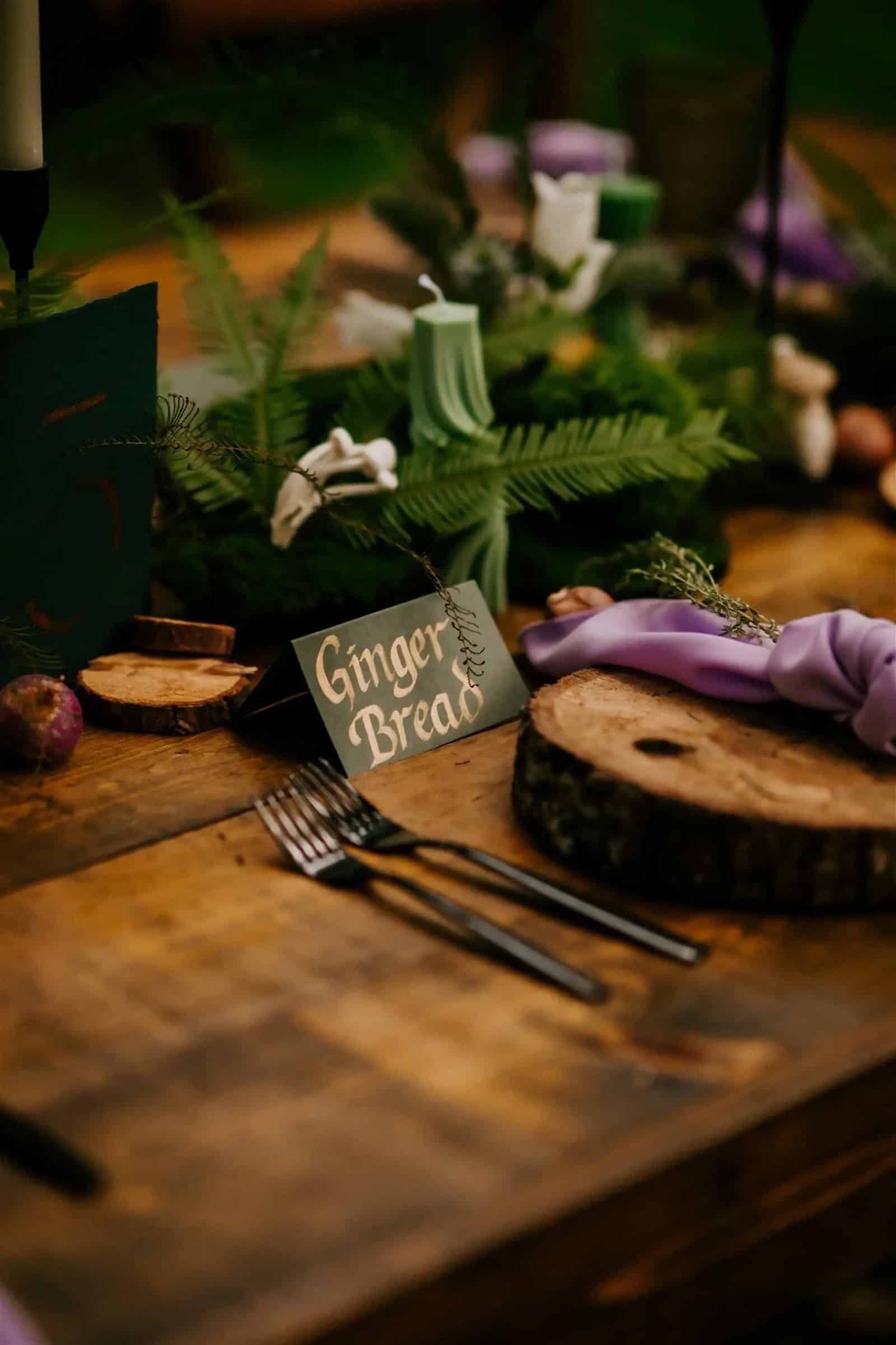 Whimsical woodland wedding place setting featuring Gabro vintage glassware and modern metallic silverware