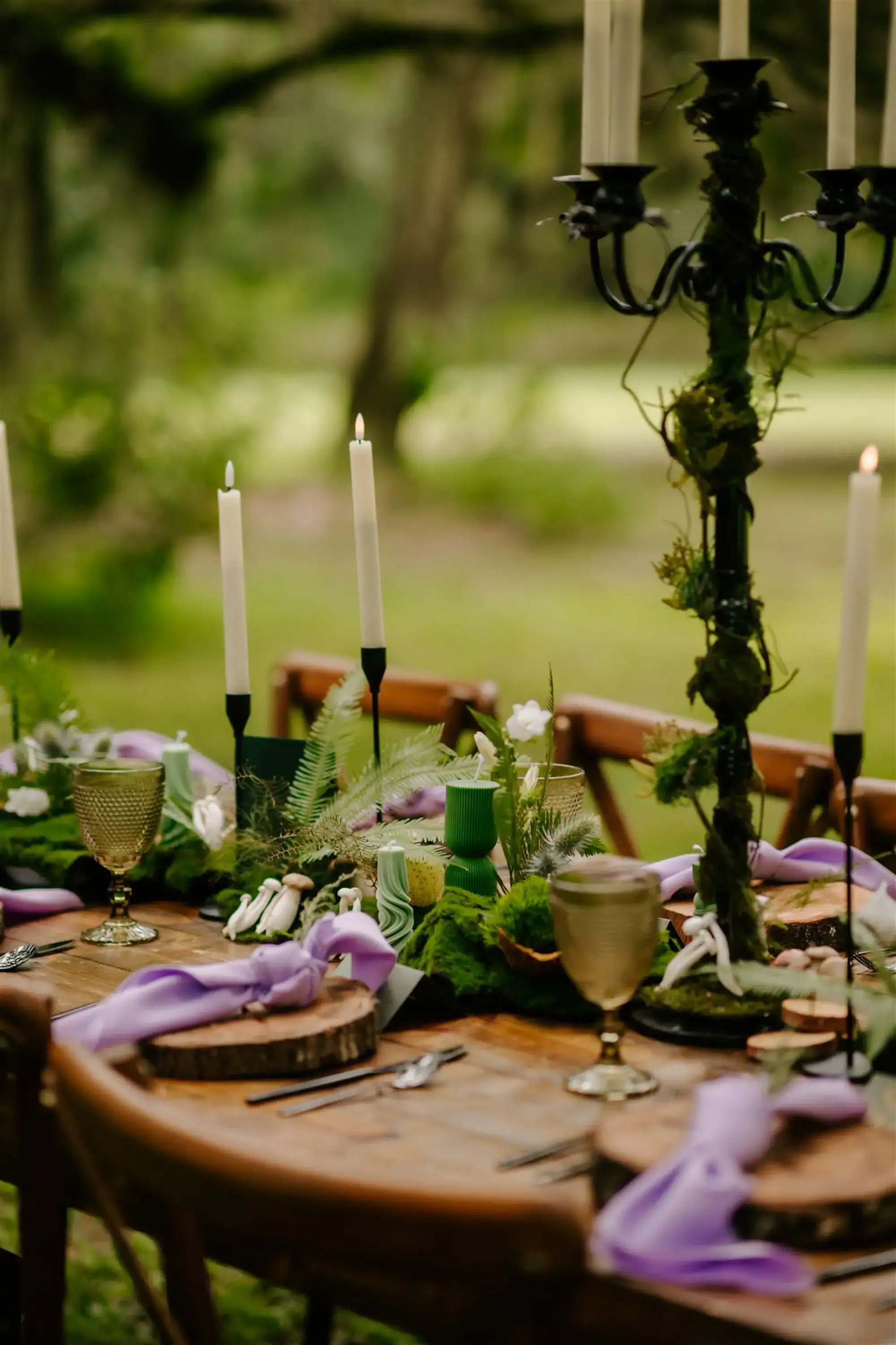Enchanted forest wedding reception tablescape with botanical centerpiece and chargers at Mill Pond Estate