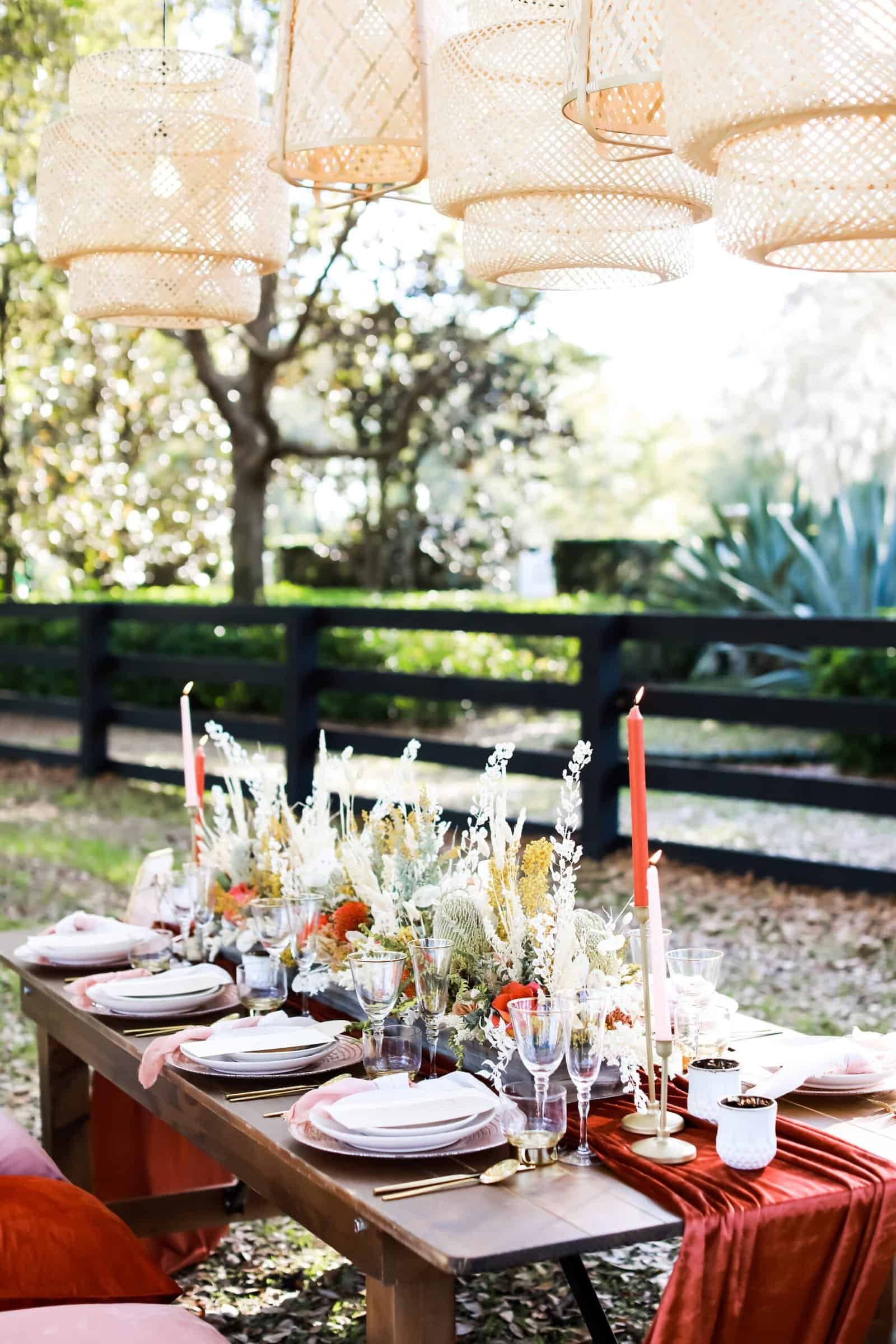 Low wood table set under the live oaks at Mision Lago Estate