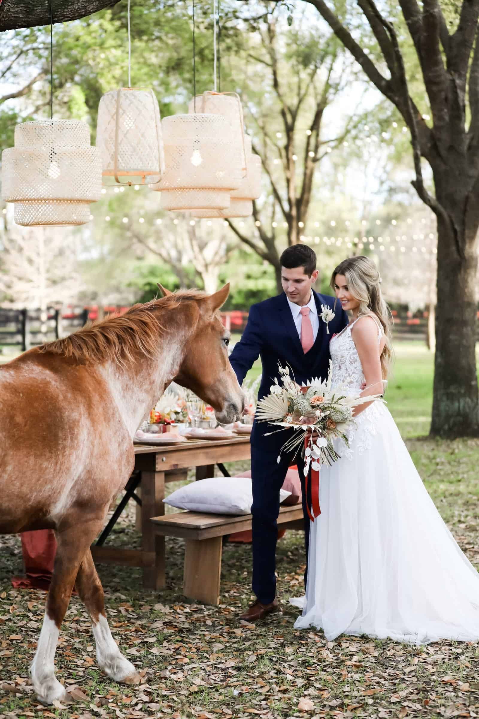 Bride and groom sunset portrait with estate horse beneath Spanish moss oaks at Mision Lago Estate