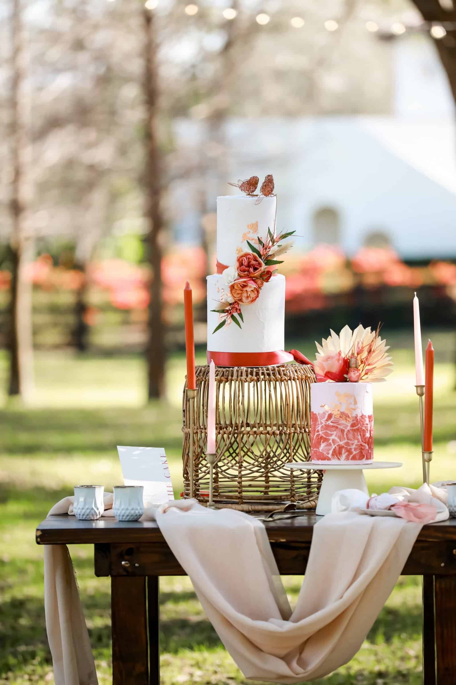 Two-tier terracotta fondant wedding cake with dried pampas grass on gold cake stand