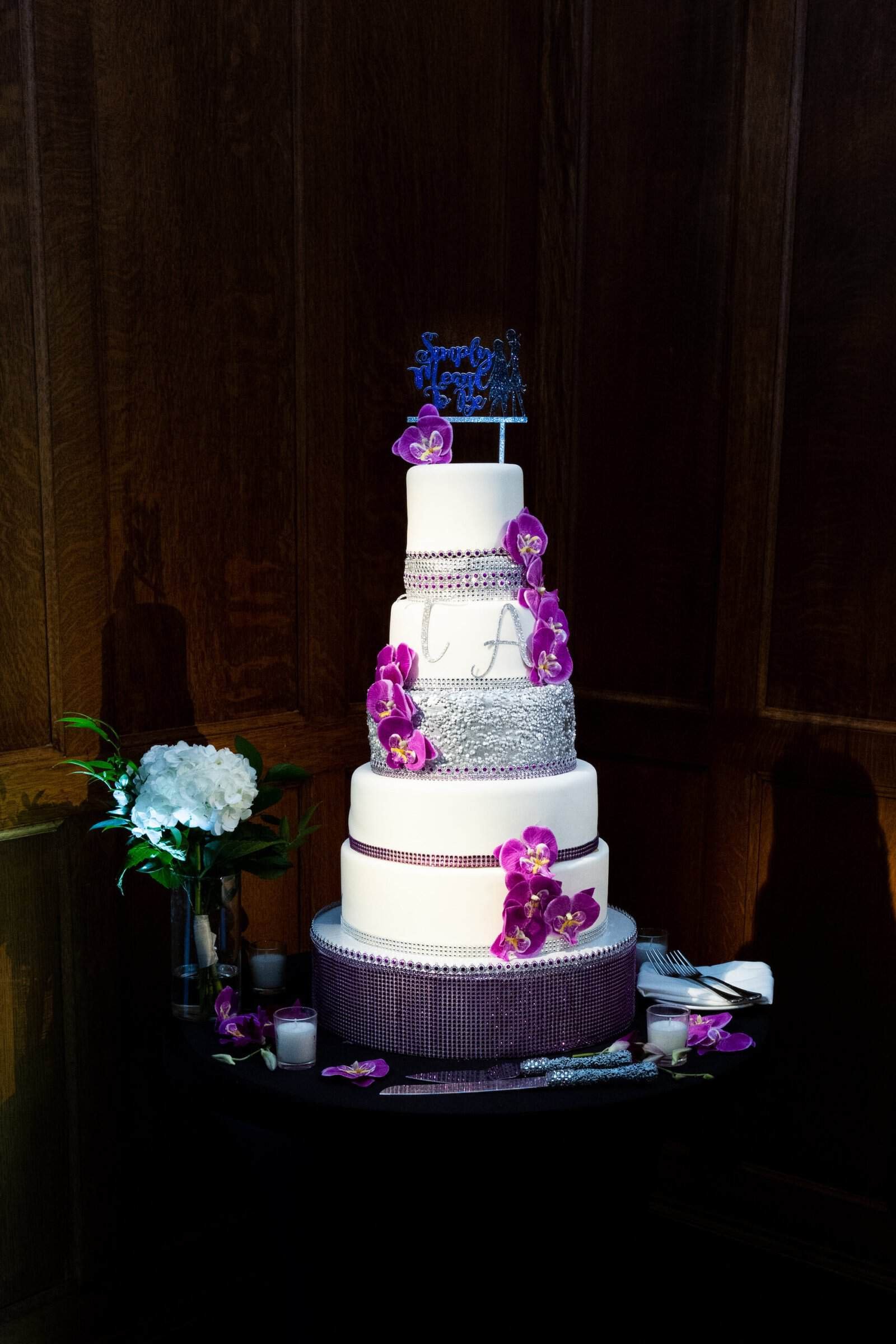 Moody purple uplighting and elegant reception tablescape at Le Meridien