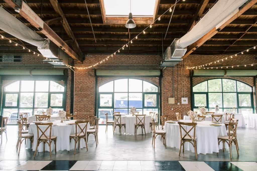 Checkered dance floor through brick warehouse reception room at Morean Center for Clay