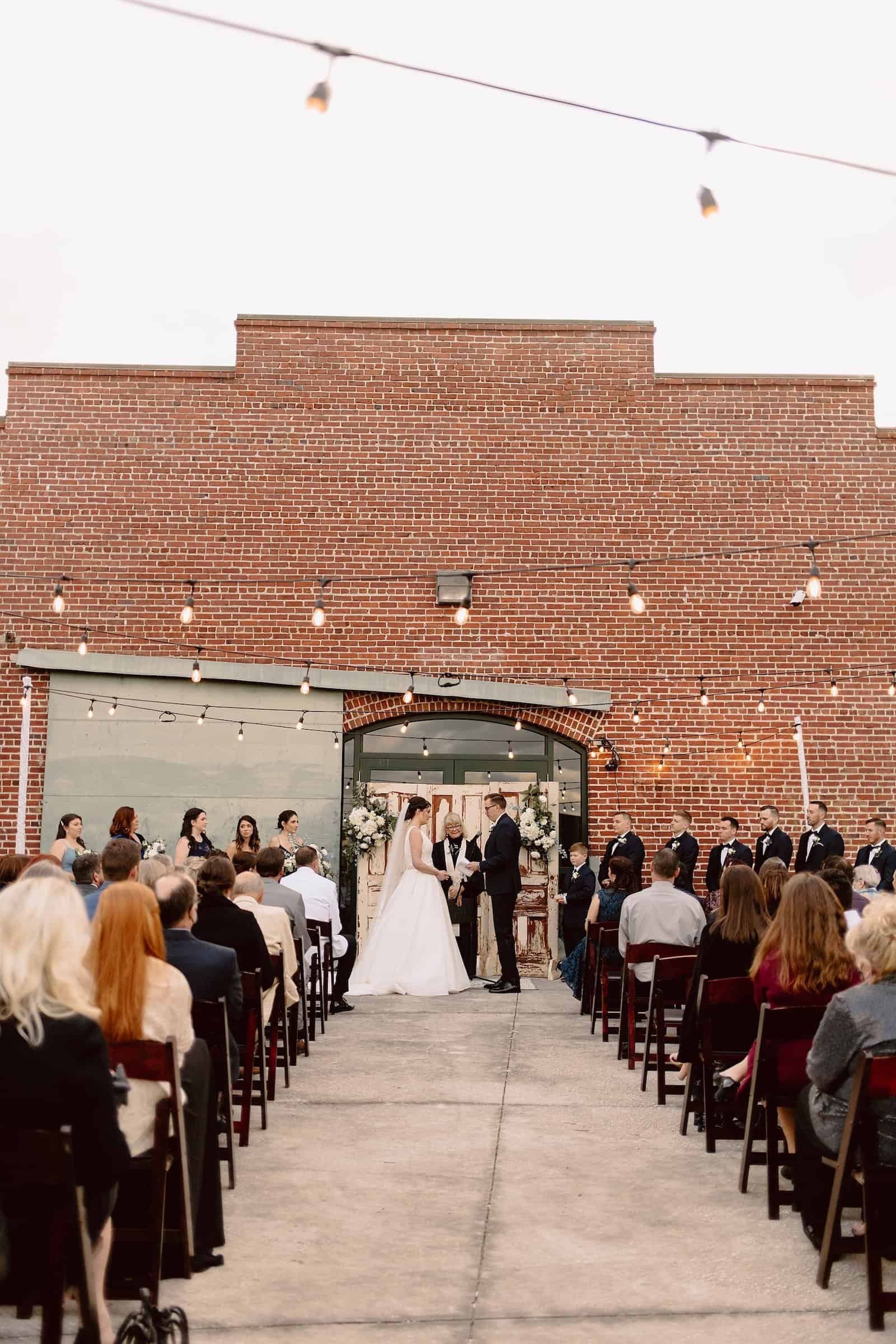 Bride and Groom Exchanging Wedding Vows at Morean Center for Clay in Downtown St. Pete