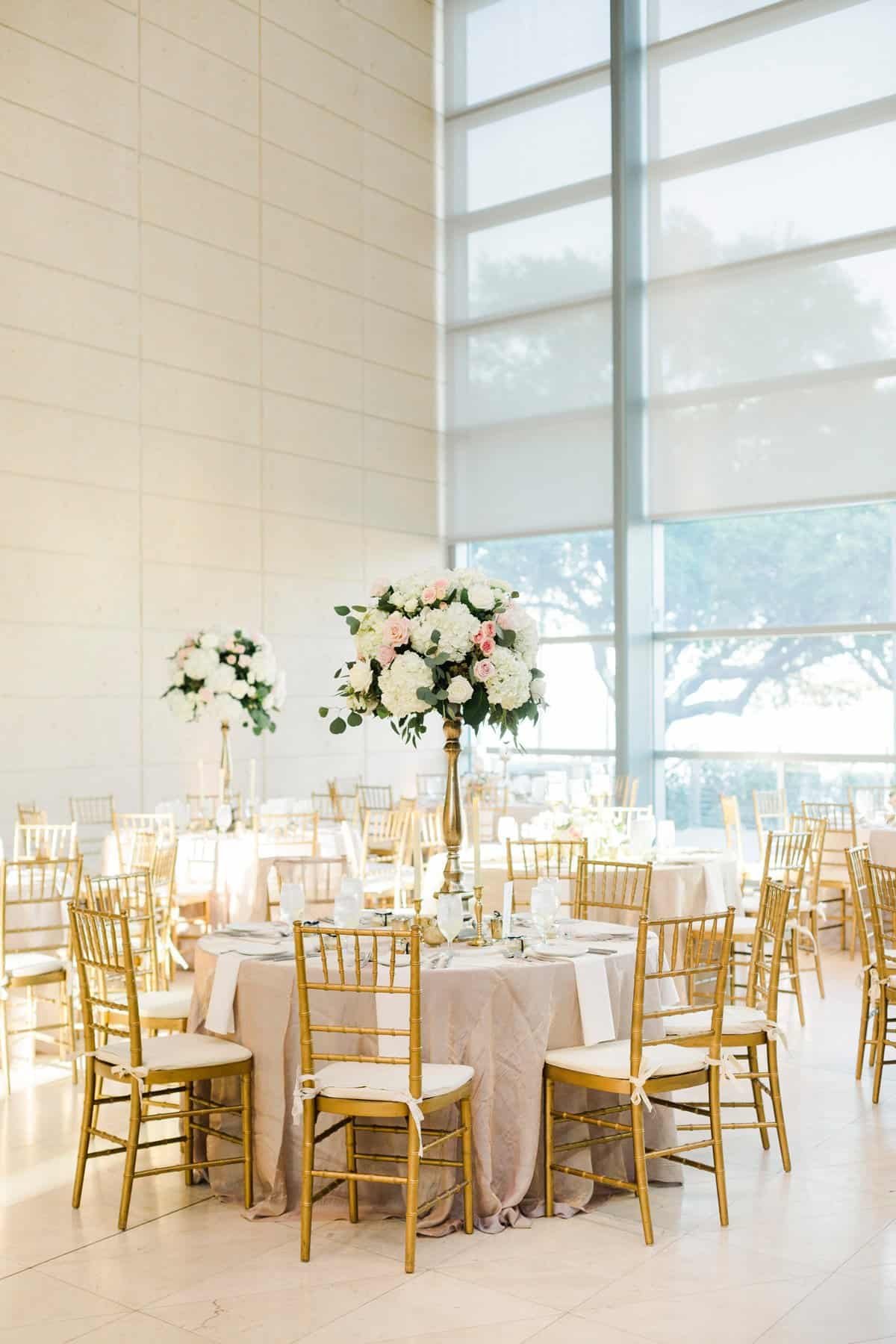 Downtown St. Pete wedding reception at Museum of Fine Arts featuring gold Chiavari chairs and tall floral centerpieces by Gabro Event Services