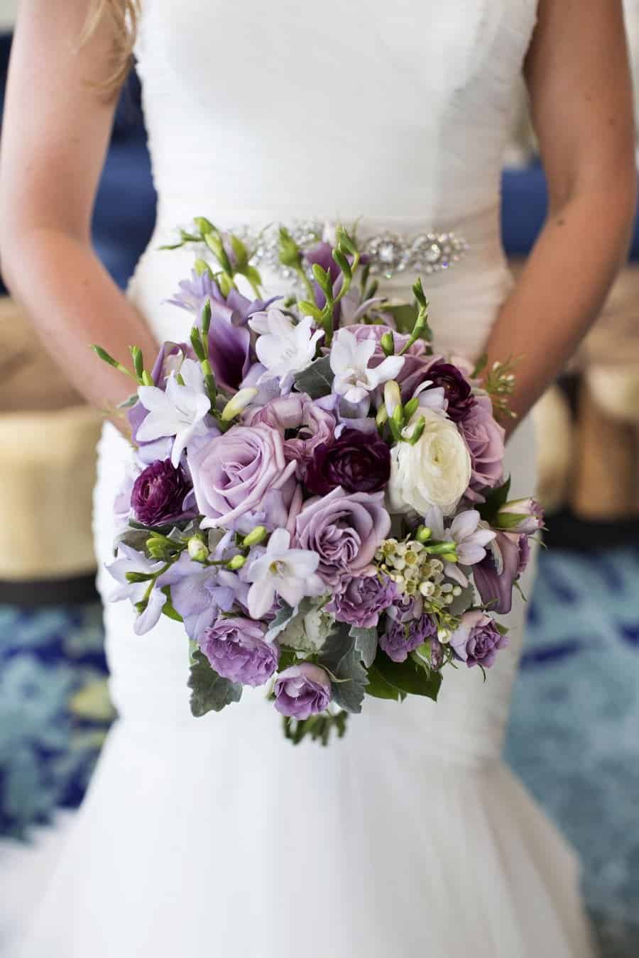 Intimate wedding reception setup at Opal Sands Resort featuring purple and silver decor accents.