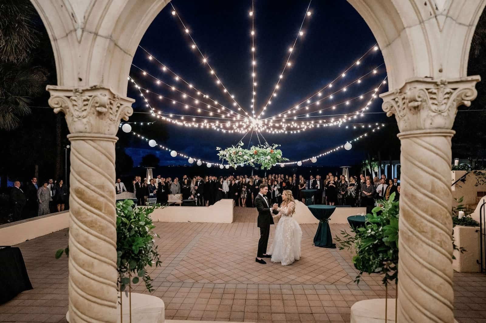 Globe string lights over the arched courtyard at the Powel Crosley Estate after dark