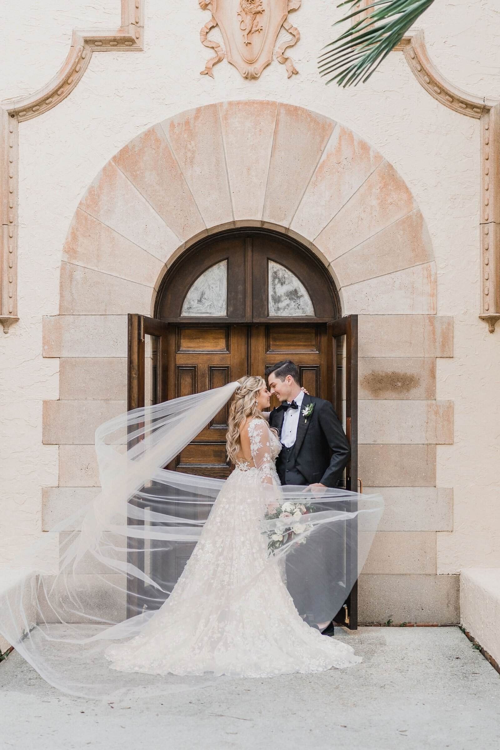 Bride and groom romantic wedding portrait along the grand loggia of Powel Crosley Estate