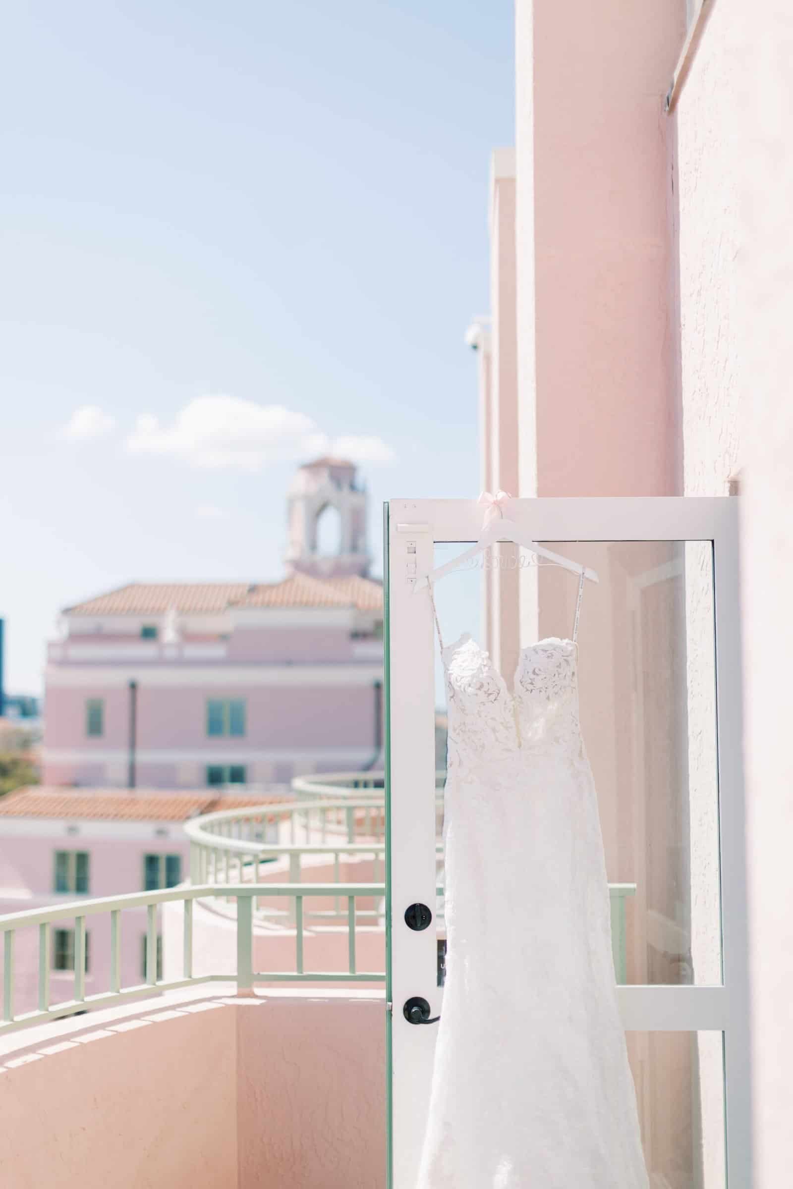 Waterfront Esplanade wedding ceremony featuring colorful ombre floral installations and rental seating at The Vinoy