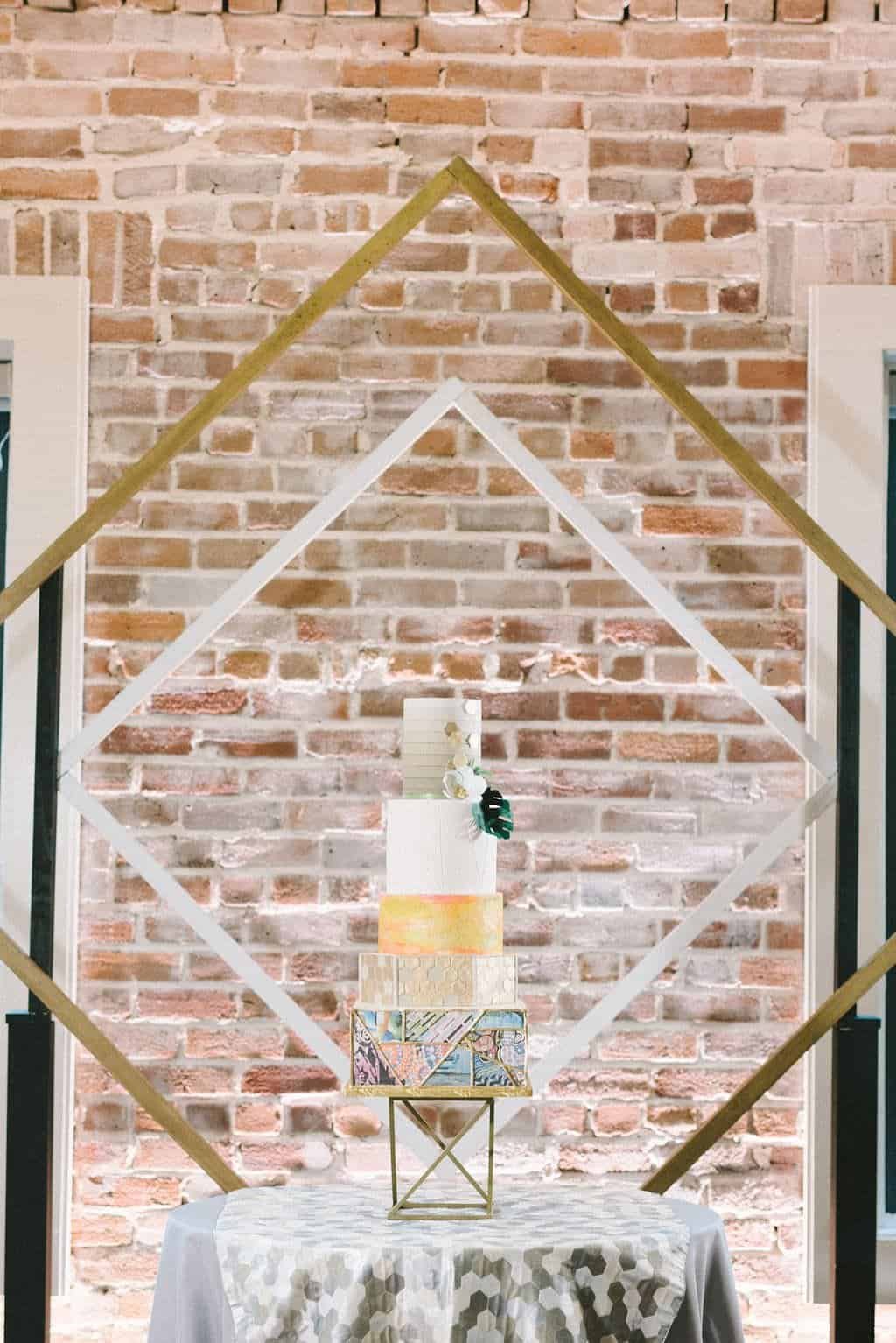 Artistic Five-Tier St. Pete Mural Inspired Wedding Cake with Gold Geometric Backdrop by Gabro Event Services
