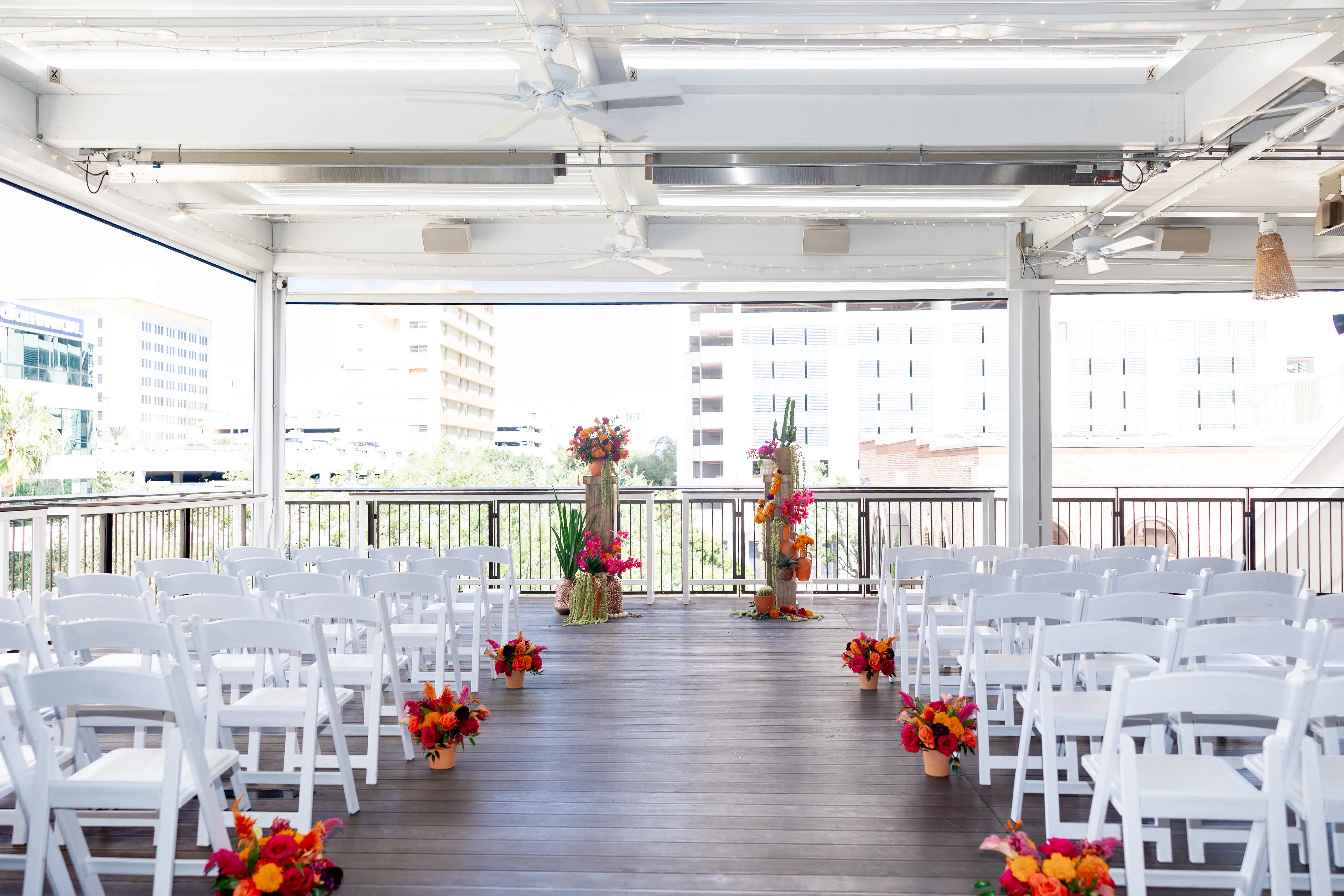 Open-air rooftop ceremony with geometric arch and sunset views at Red Mesa Events