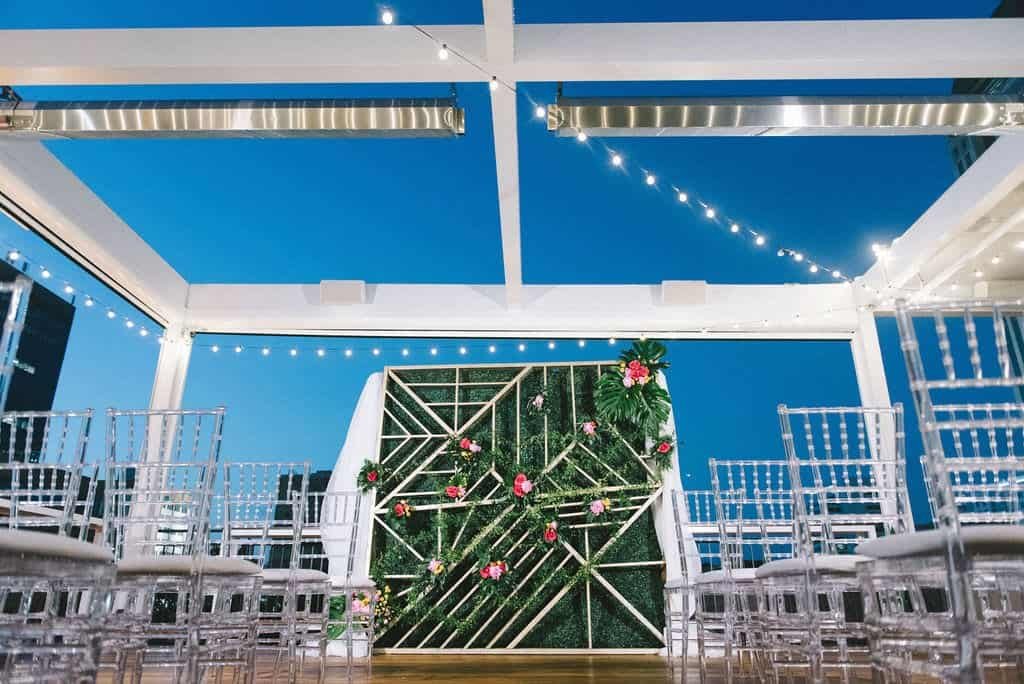 Modern Rooftop Wedding Ceremony Decor at Red Mesa Events with Ghost Chairs and String Lights by Gabro Event Services