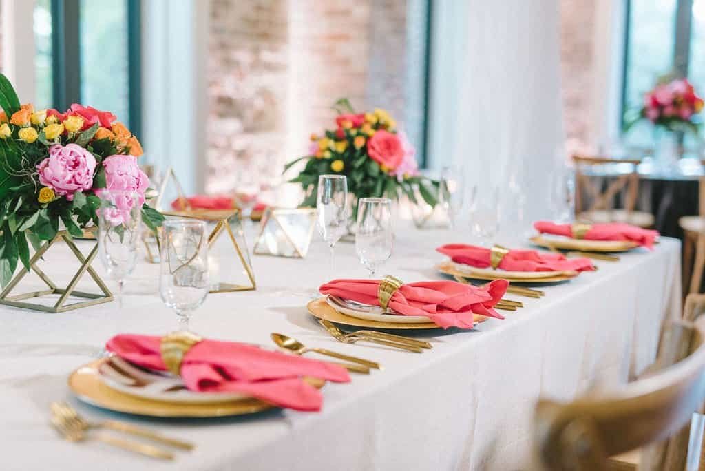 Vibrant Tropical Reception Tablescape with Gold Chargers, Bright Linens, and High Centerpieces by Gabro Event Services