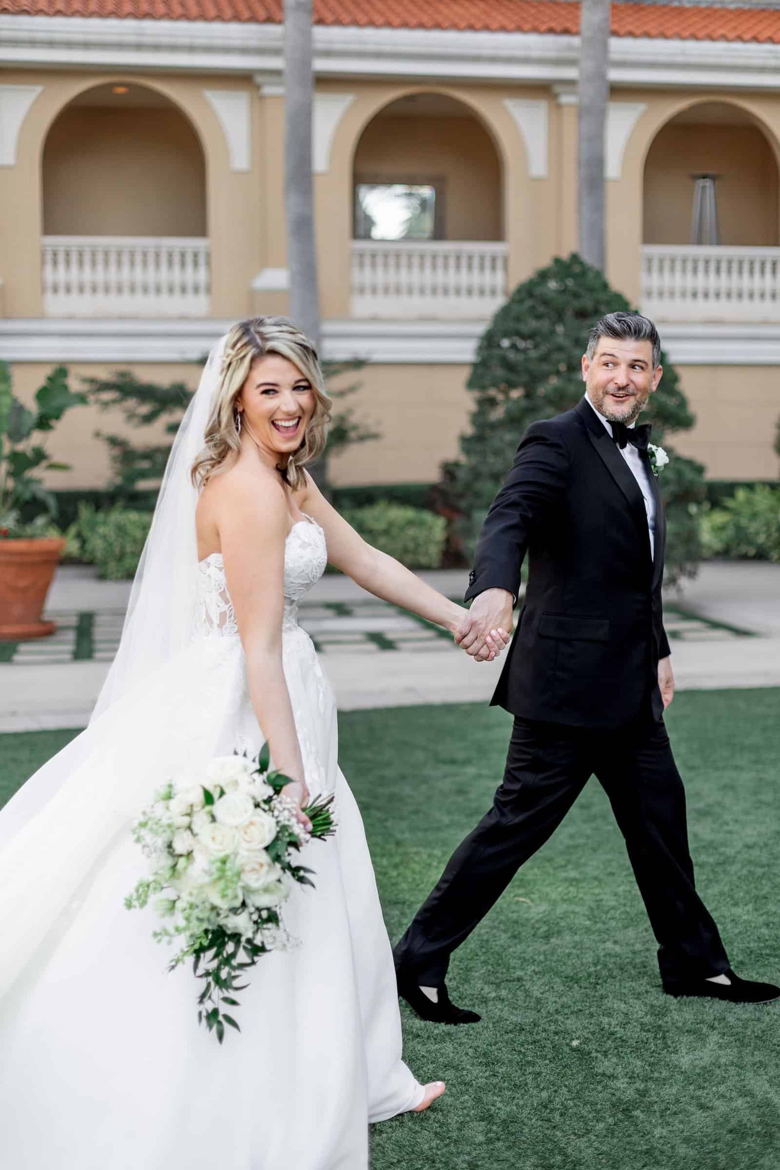 Celebratory wedding reception with energetic dance floor lighting and lively musical entertainment at The Ritz-Carlton Sarasota