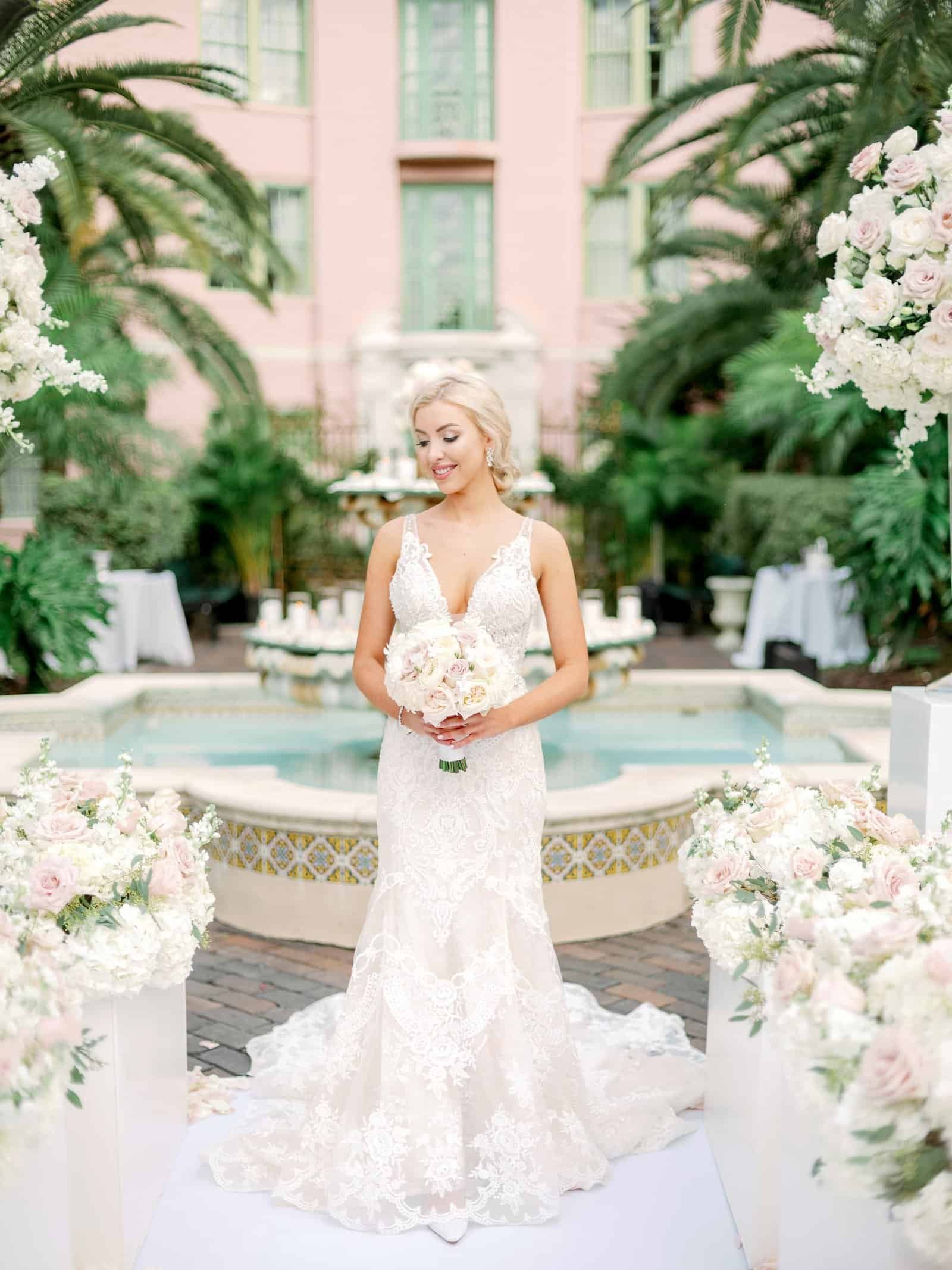 Bride and Groom Sweetheart Table Set with Gilded Charger Plates, Flowing Chiffon Drapes, and Rose Runners