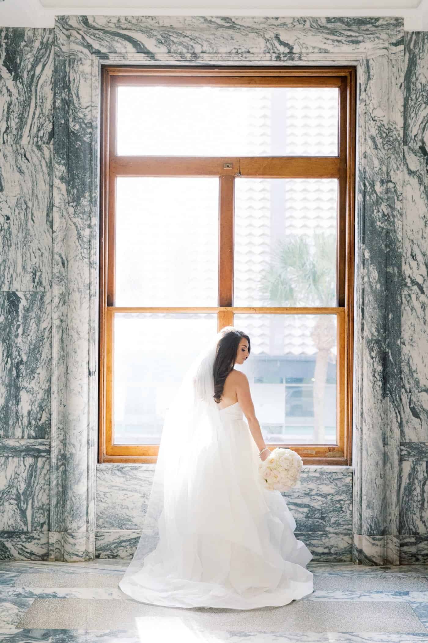 Bride in Hayley Paige Strapless Ballgown Wedding Dress Holding Classic Floral Bouquet by Gabro Event Services