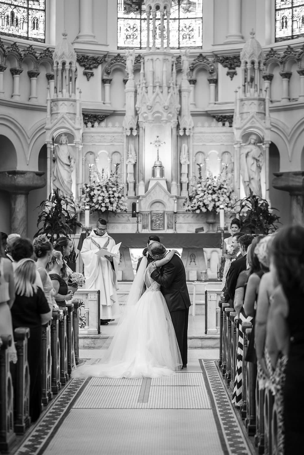 Bride and groom at the altar of Sacred Heart Catholic Church in downtown Tampa during their wedding ceremony