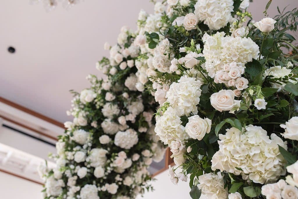 Ceremony Arch Floral Detail with White Hydrangeas Blush Roses and Lush Greenery by Gabro Event Services
