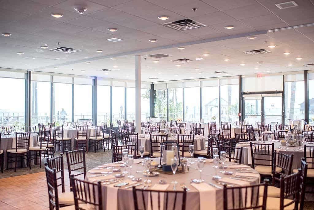 Bride and groom sharing their first dance beneath illuminated ballroom draping and intelligent lighting at Sandpearl Resort