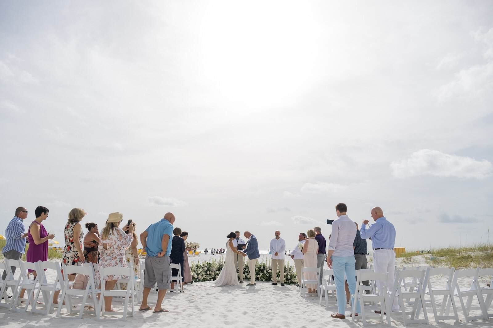 Elegant Wedding Reception Ballroom at Sandpearl Resort with Floor-to-Ceiling White Draping and Ghost Seating