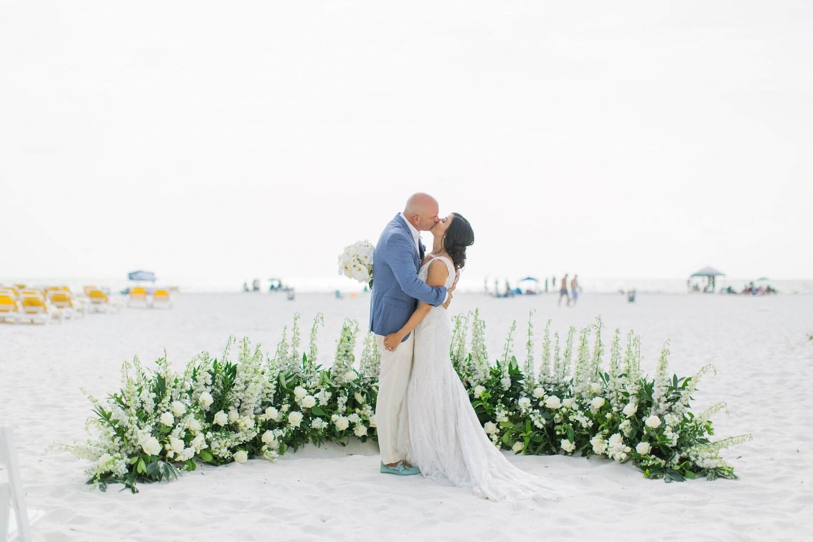 Modern Coastal Tablescape Featuring Crystal Glassware, Beaded Chargers, and Lush White Rose Florals