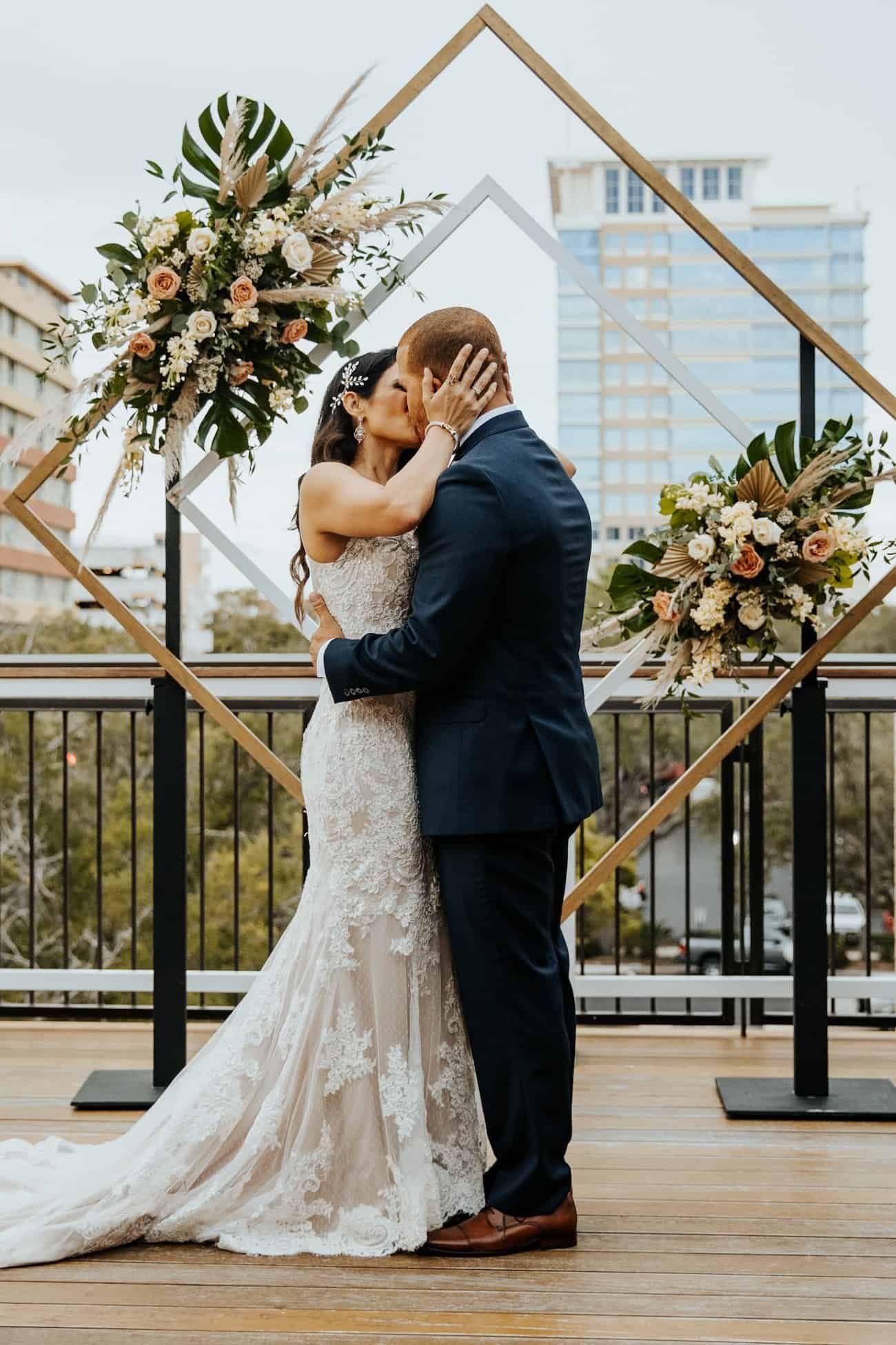 Newlyweds Sharing First Dance on Gleaming White Dance Floor Beneath Grand Chandelier