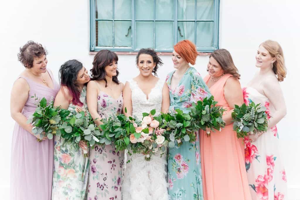 Bridesmaids Wearing Mismatched Floral Print Pastel Dresses on the Green Lawns