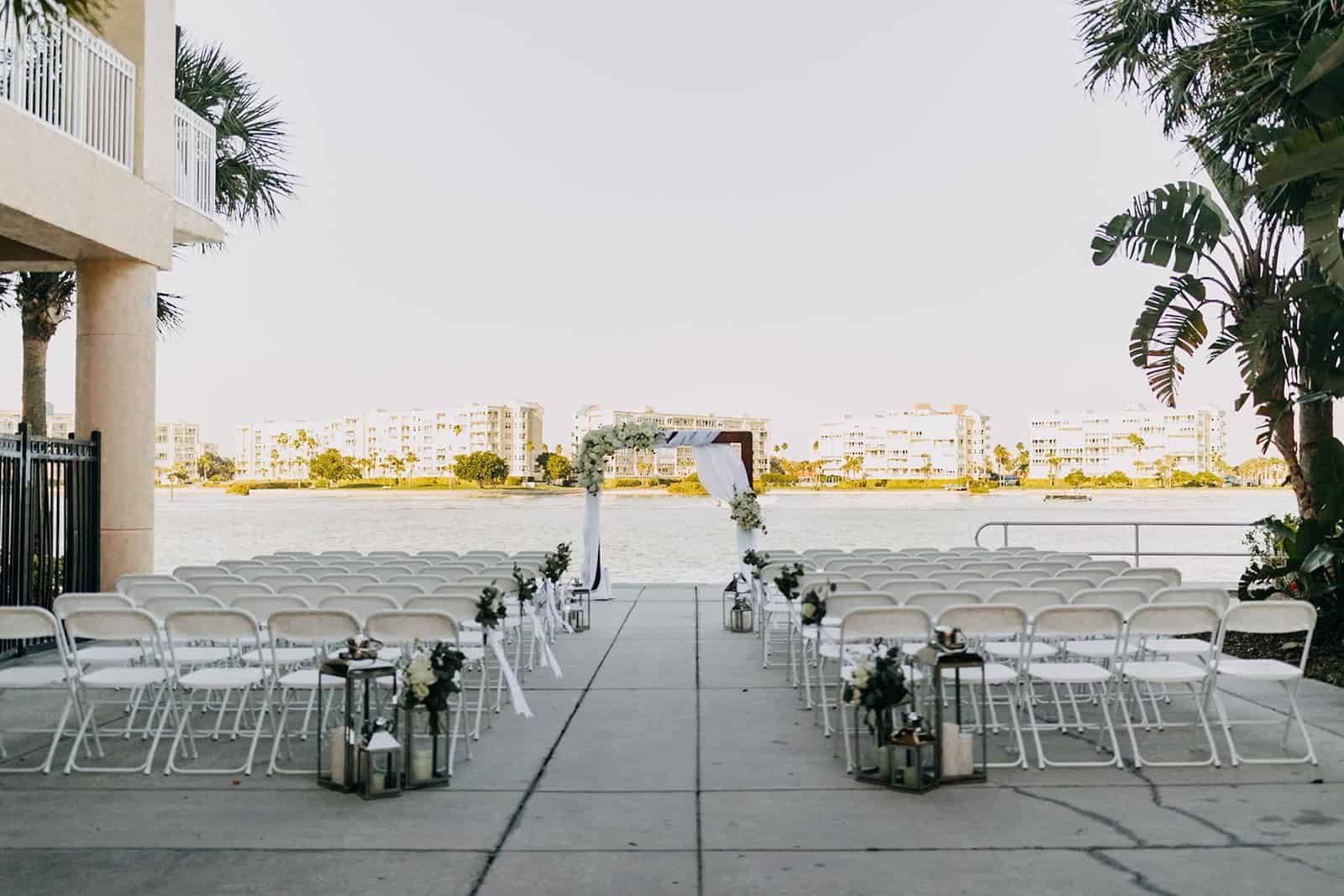 Waterfront Wedding Ceremony with Wooden Arch and Silver Chiavari Chairs by Gabro Event Services