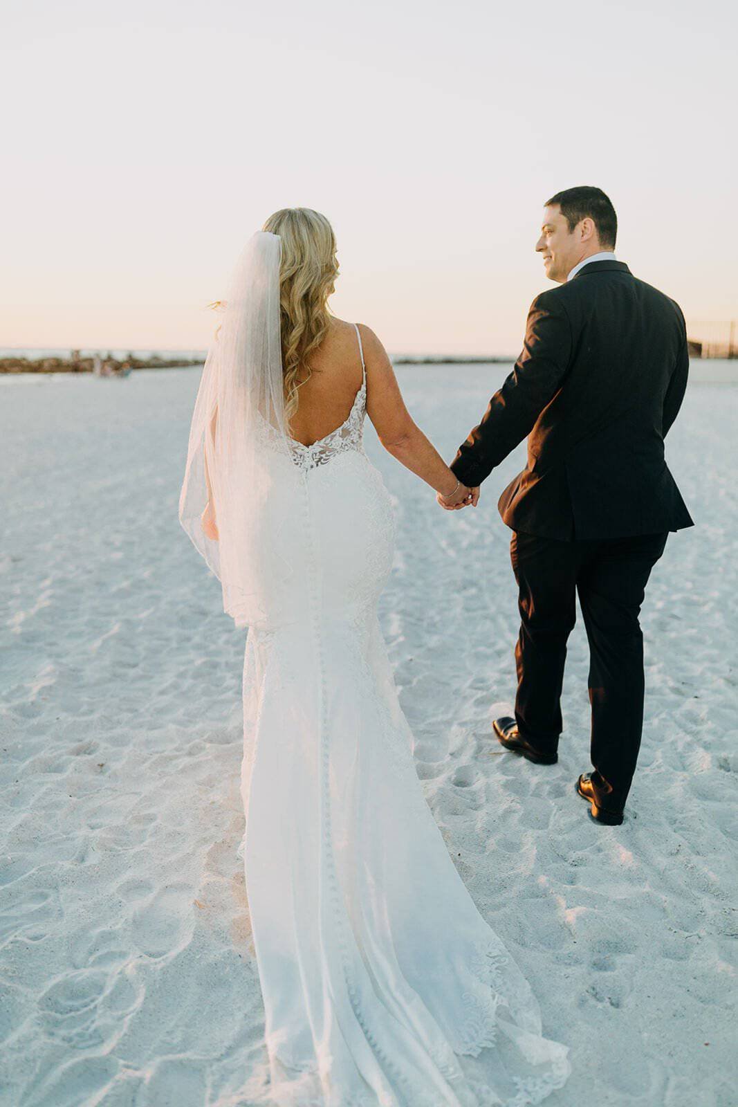 Bride in Lace Trumpet Gown and Groom on the Shores of St. Pete Beach