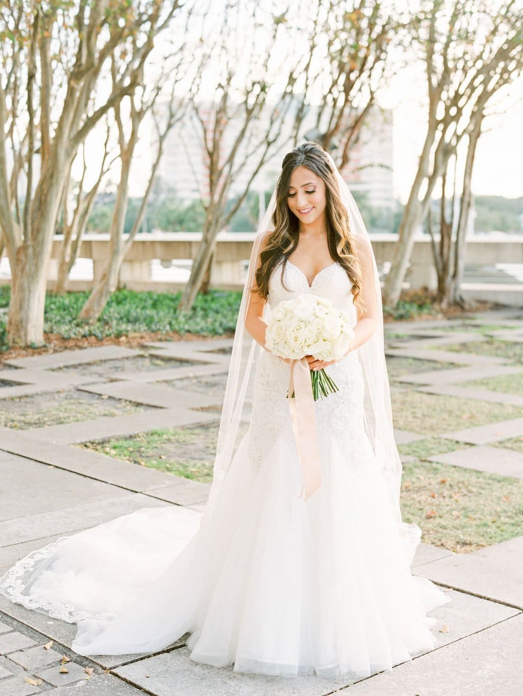 Reception dining table decorated with peach florals, vintage mint accents, and glowing candlelight at an outdoor St. Pete wedding