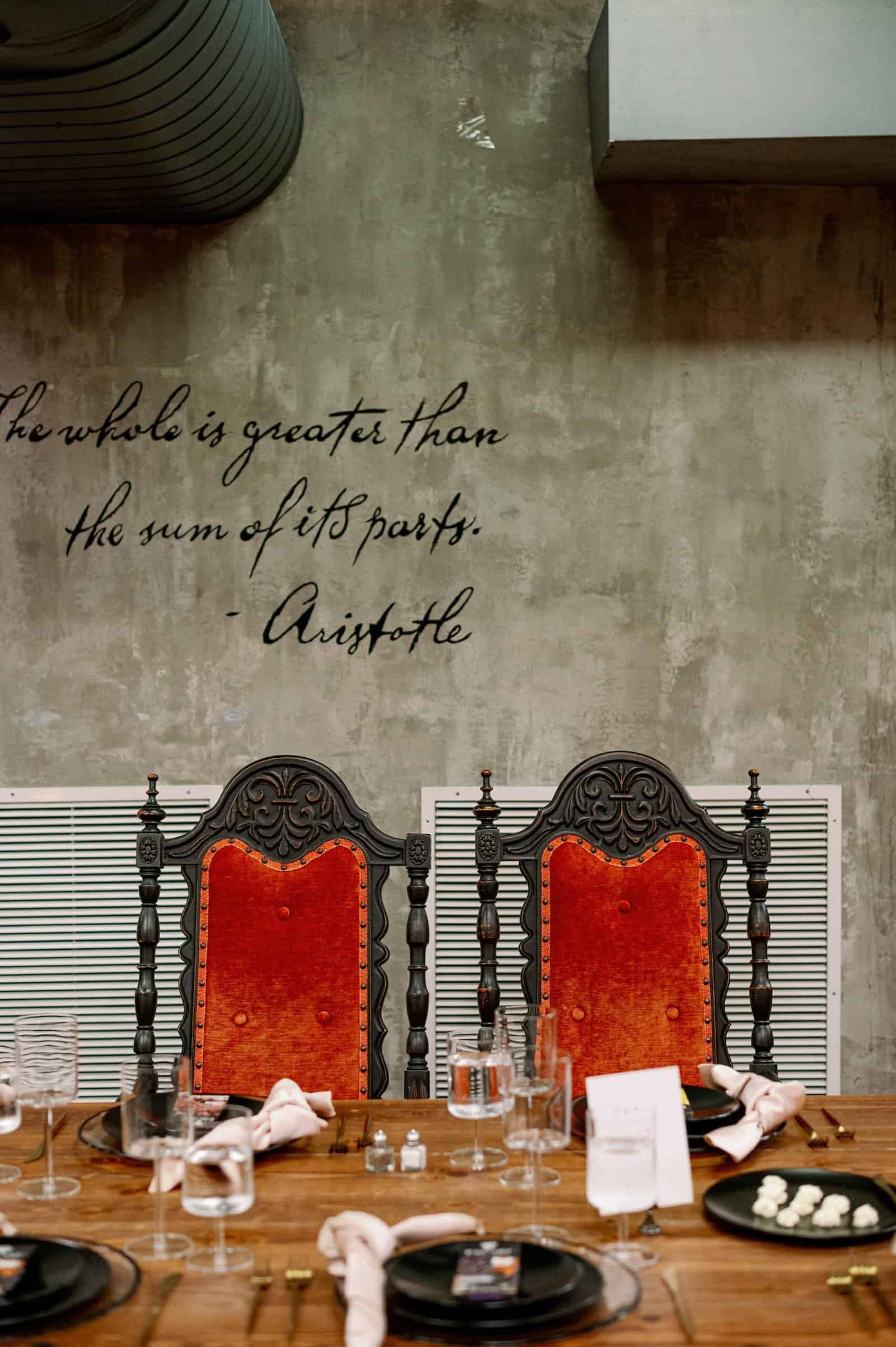 Sweetheart table styled with crimson red velvet vintage armchairs from Gabro Event Services