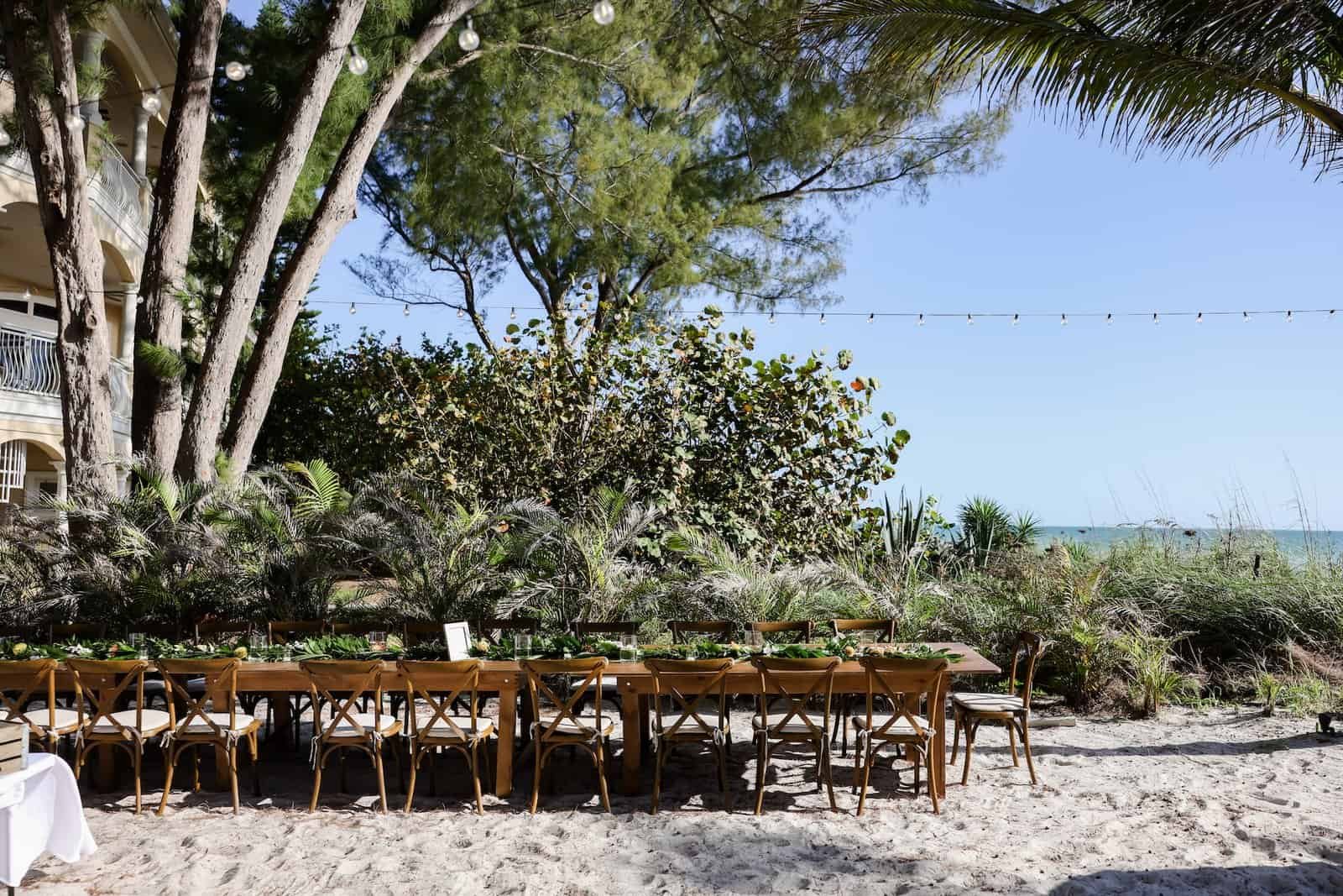 Open-Air Beachfront Reception Feasting Tables and Wood Crossback Chairs by Gabro Event Services