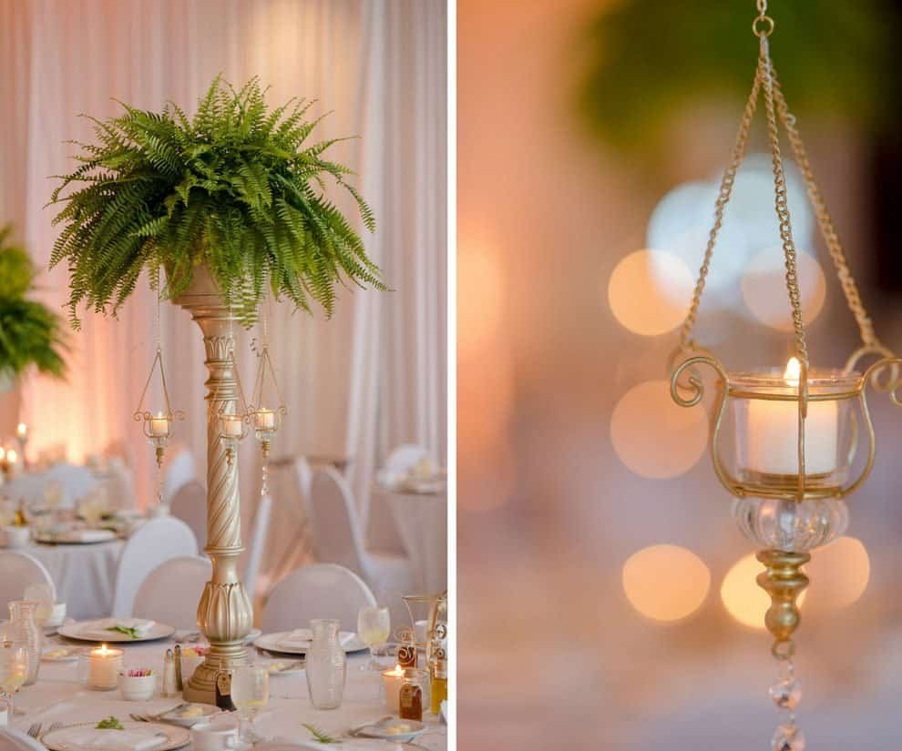 Tall gold geometric centerpieces with lush ferns and hanging glass votives at a Tampa Garden Club reception
