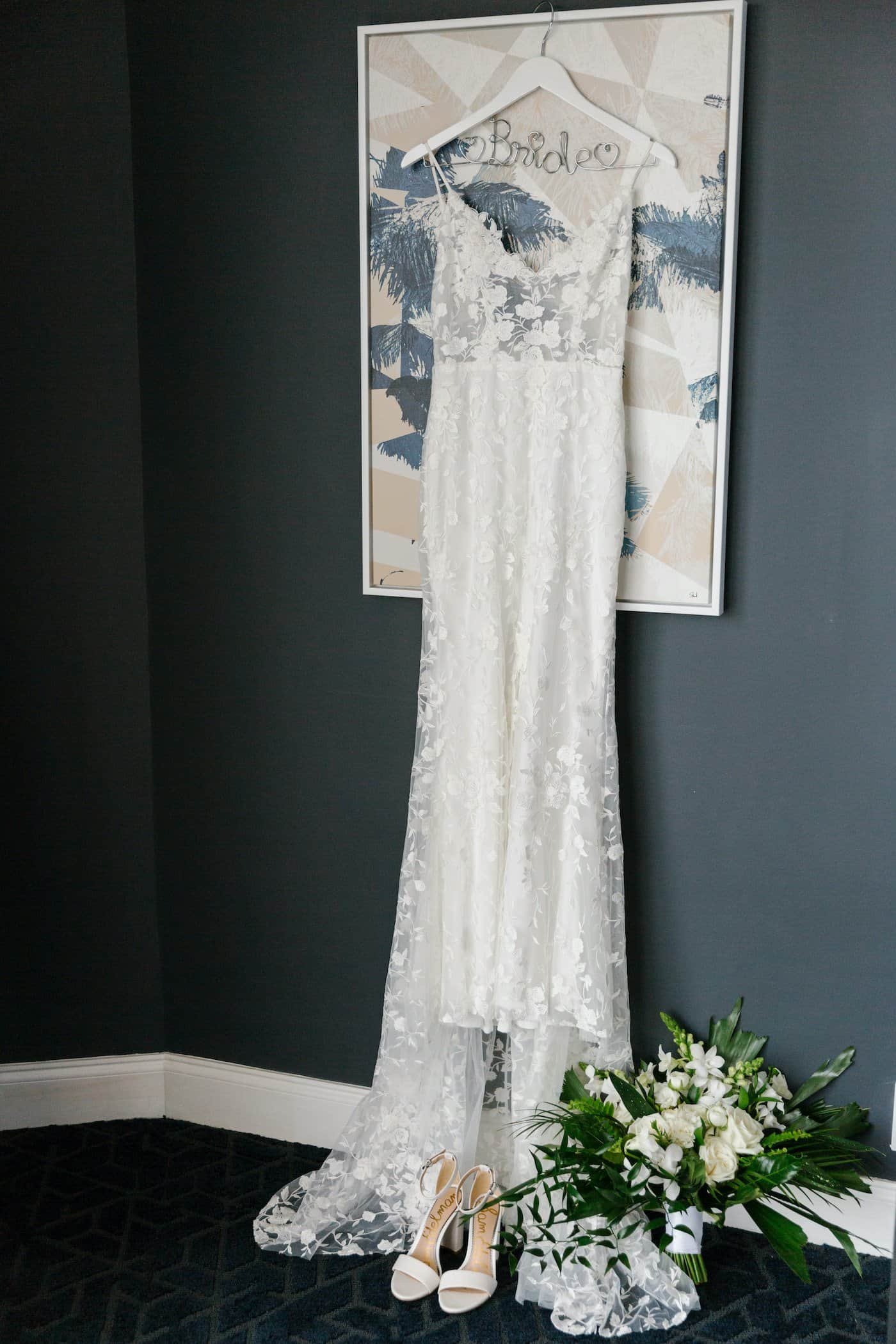 Outdoor wedding ceremony arch with flowing white draping and delicate floral installations on the garden lawn