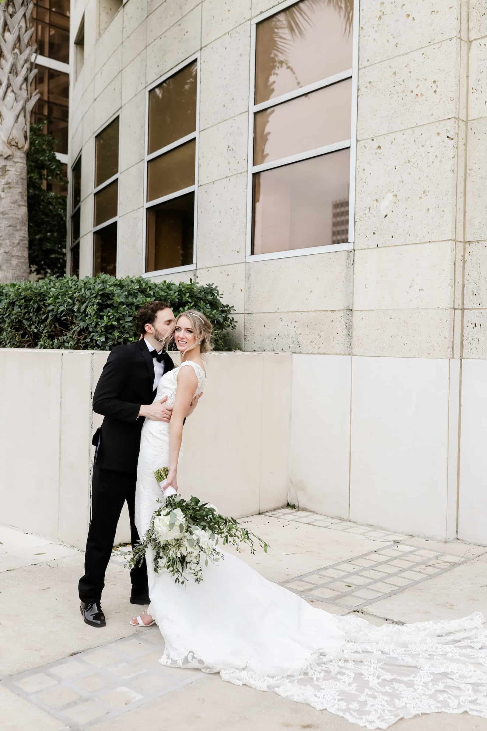 Couple First Dance on High-Gloss White Dance Floor Surrounded by Guests and Warm Accent Lighting