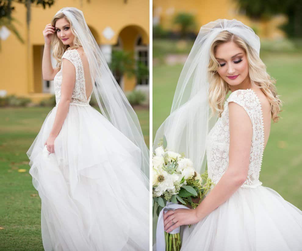 Bride in flowing lace wedding gown posing under majestic oak trees at Tampa Palms Golf and Country Club