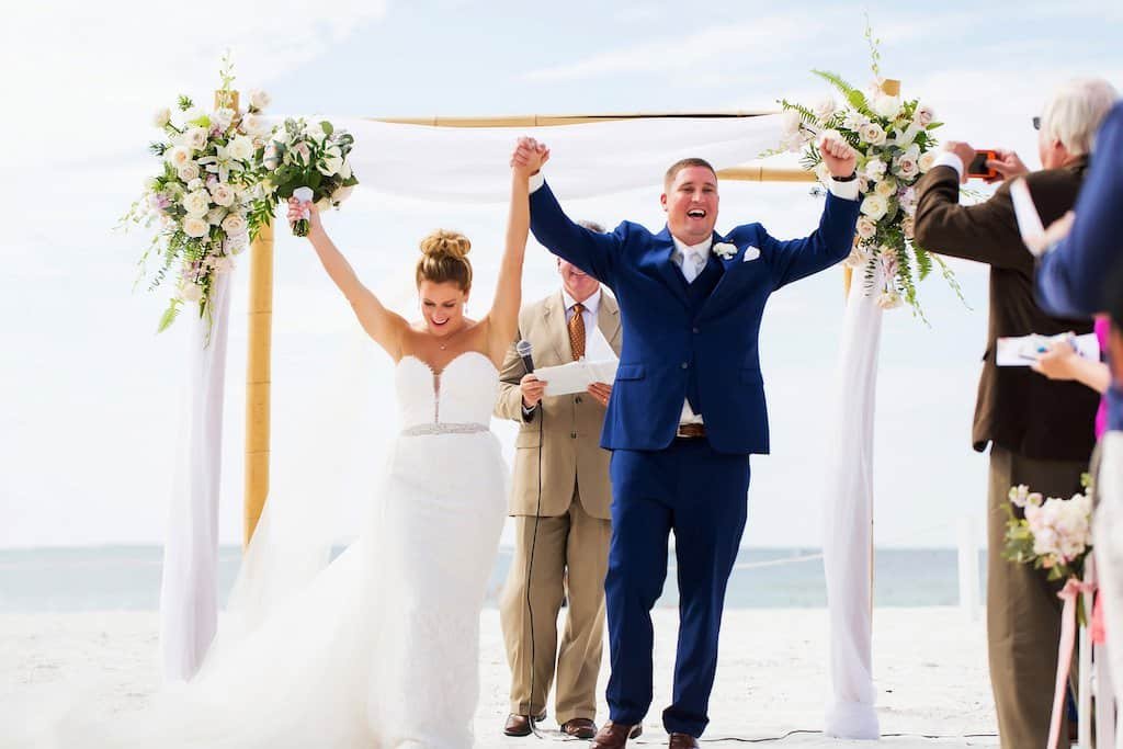 Sweetheart table draped in sparkling rose gold sequin fabric with lush floral arrangements and backdrop at Tampa Palms