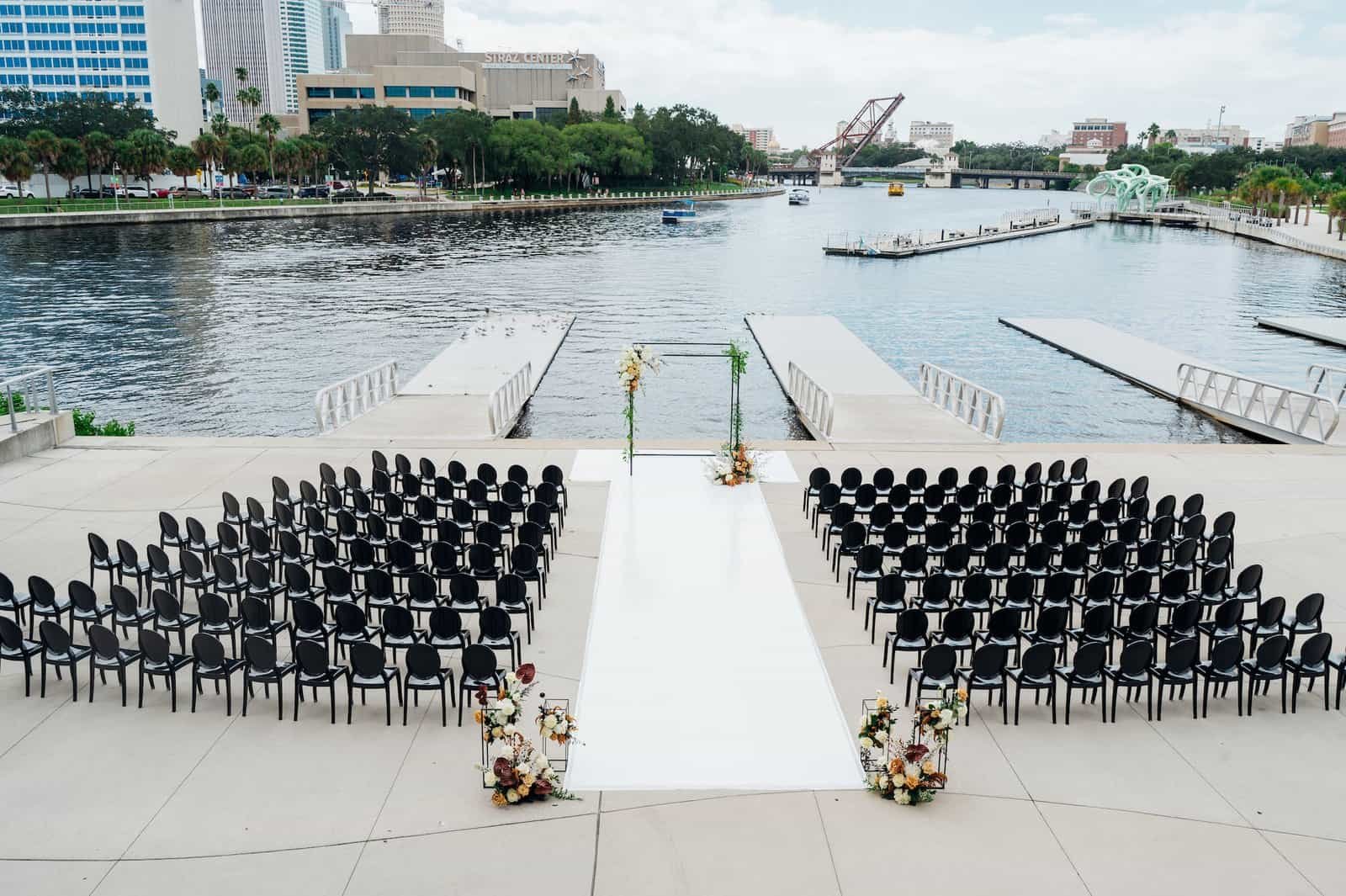 A sophisticated wedding reception setup featuring black and bronze decor at Tampa River Center.
