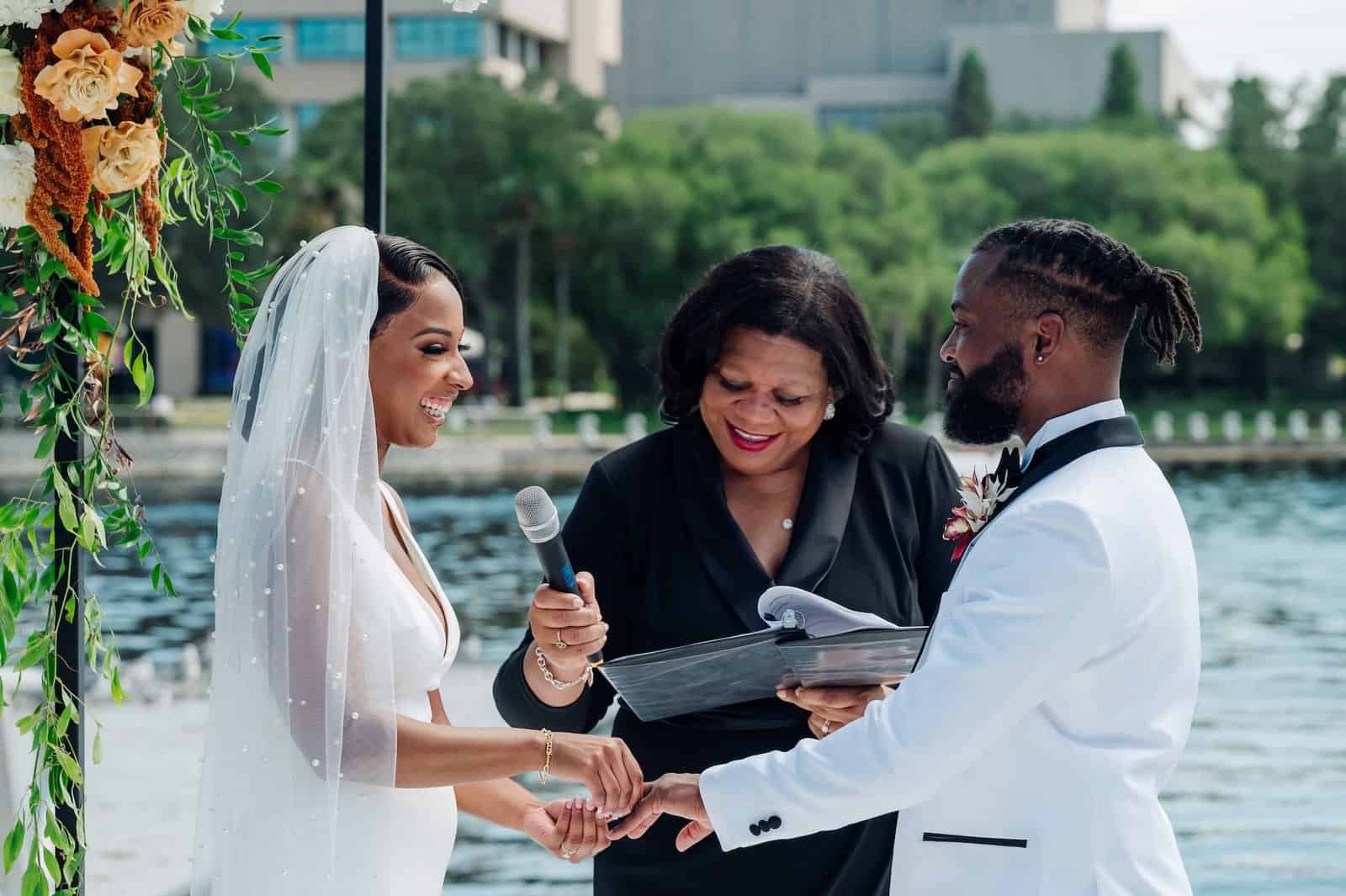 The bride and groom exchanging vows outdoors at the Tampa River Center.