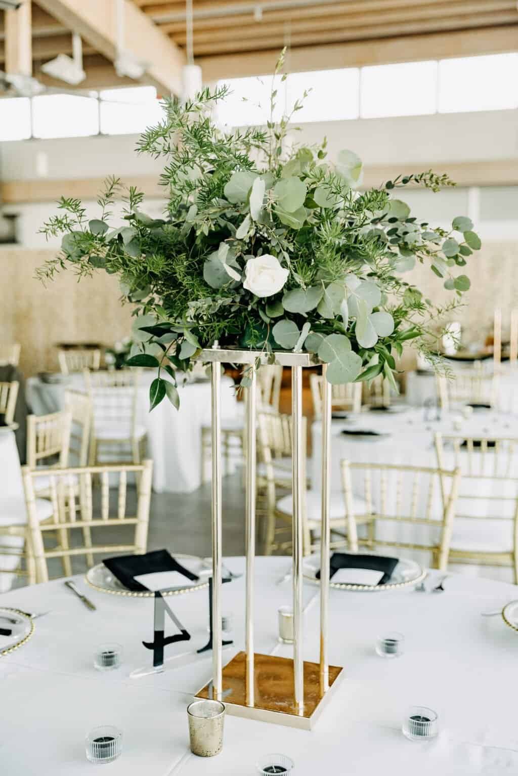 Gold Chiavari chairs pulled up to a set table at the Tampa River Center