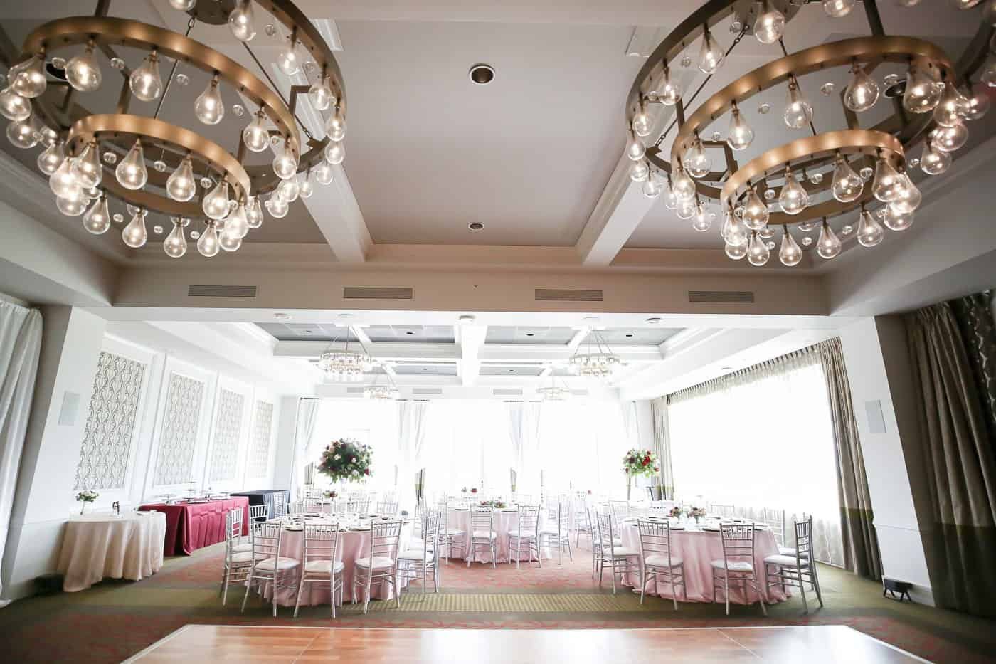 The Birchwood Grand Ballroom wedding reception featuring round guest tables and silver chiavari chairs