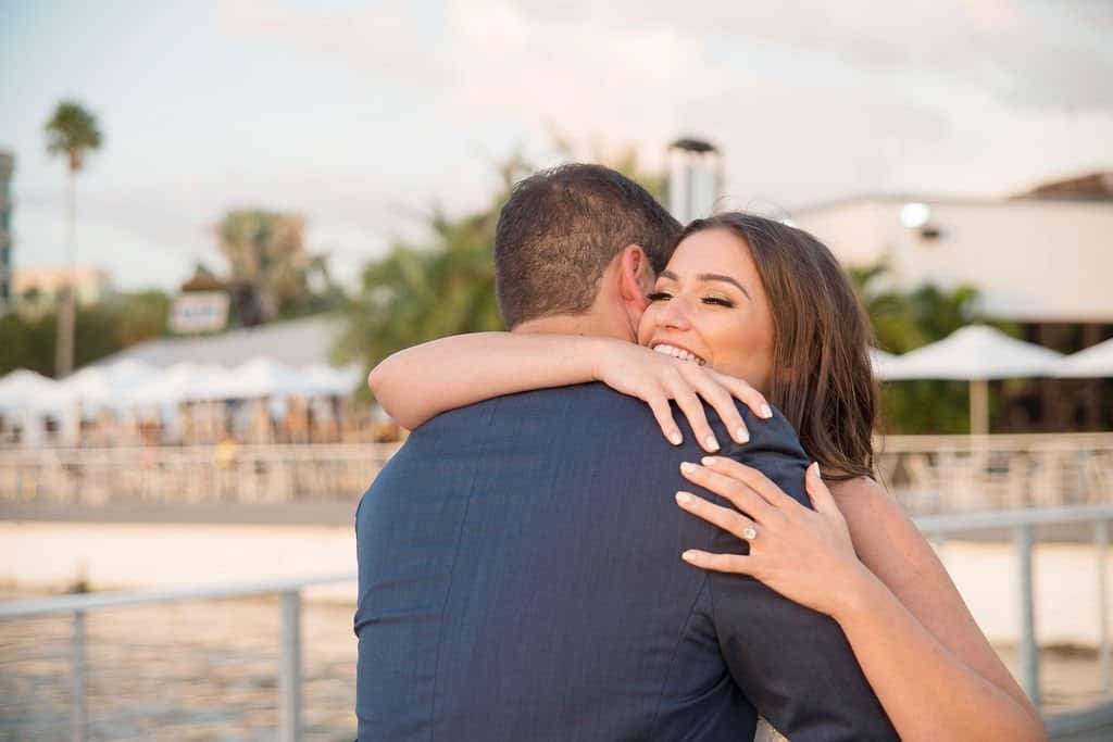 Draped white fabric accents fluttering in the breeze during a coastal ceremony.