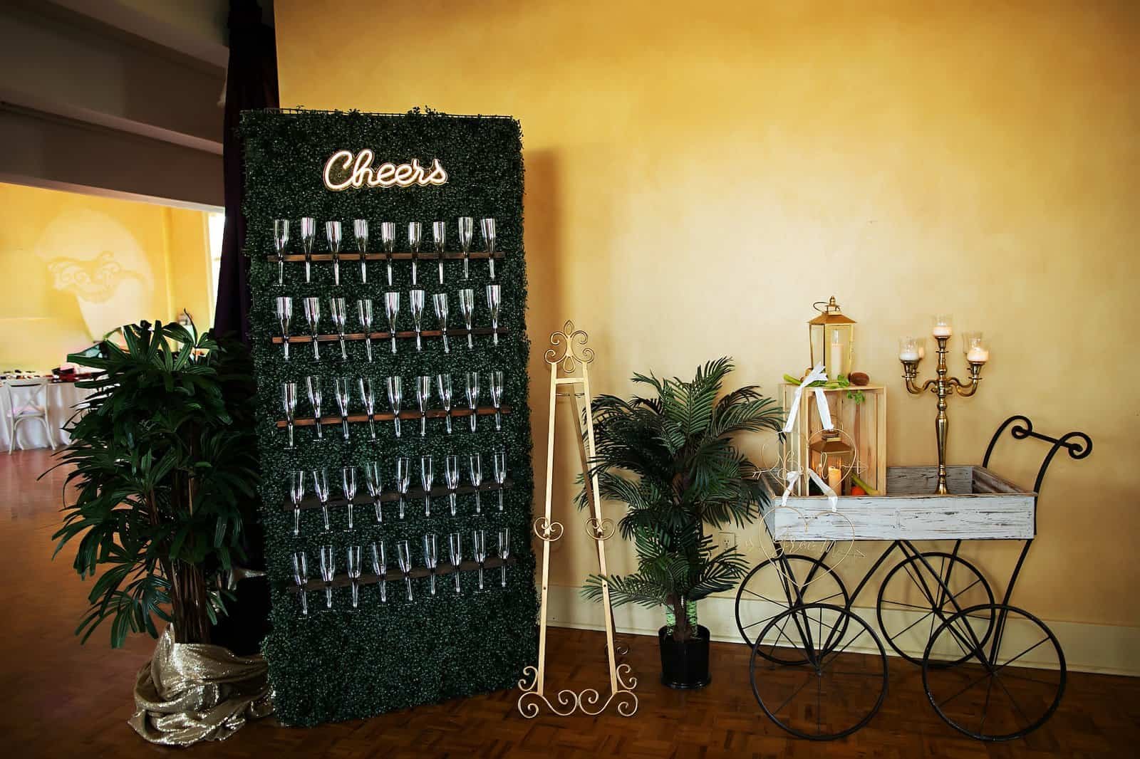 Lush tropical greenery and white accents decorating a historic theater for a wedding.
