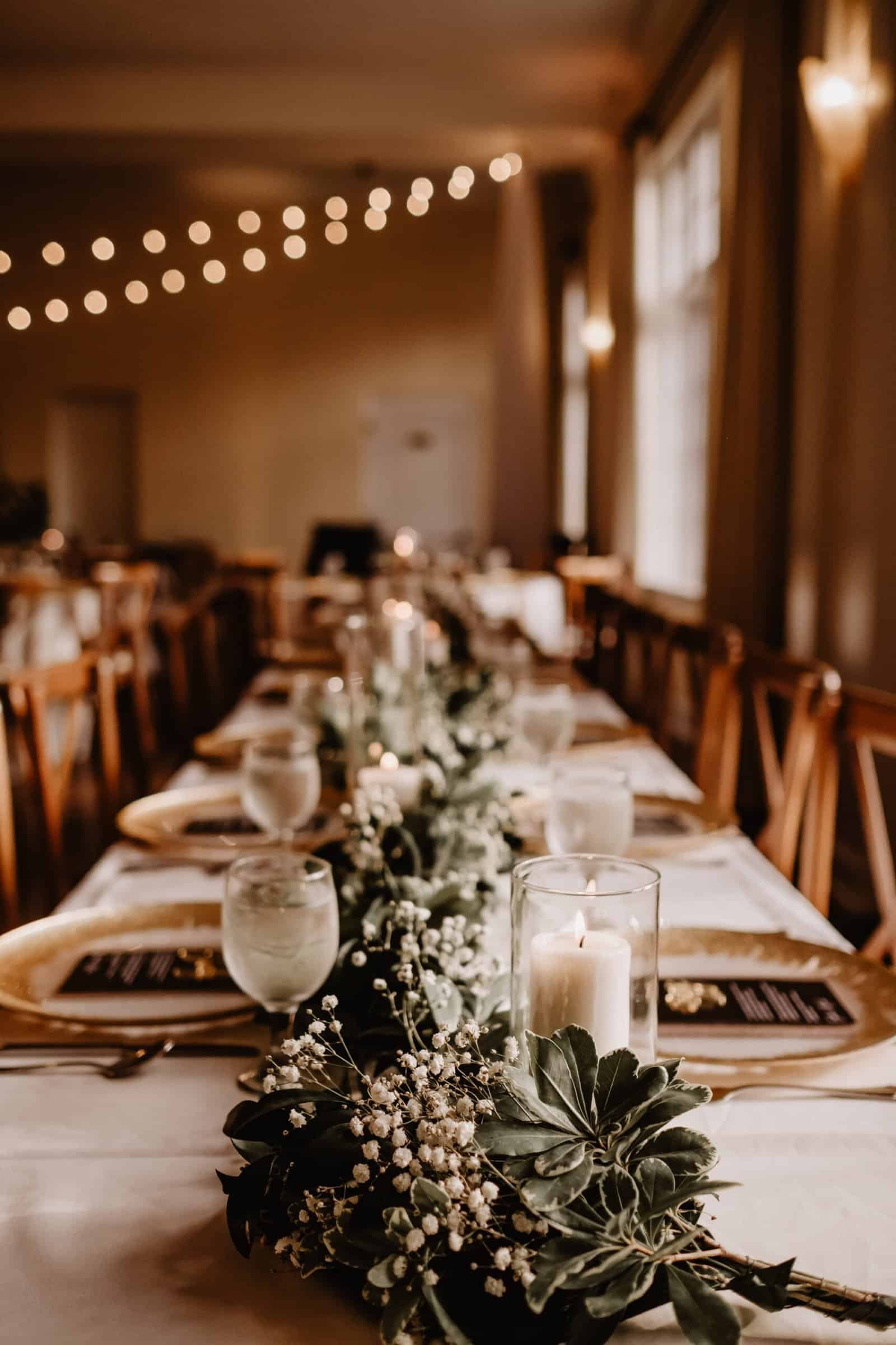 warm bistro string lighting suspended over long banquet reception tables at The Orlo Tampa
