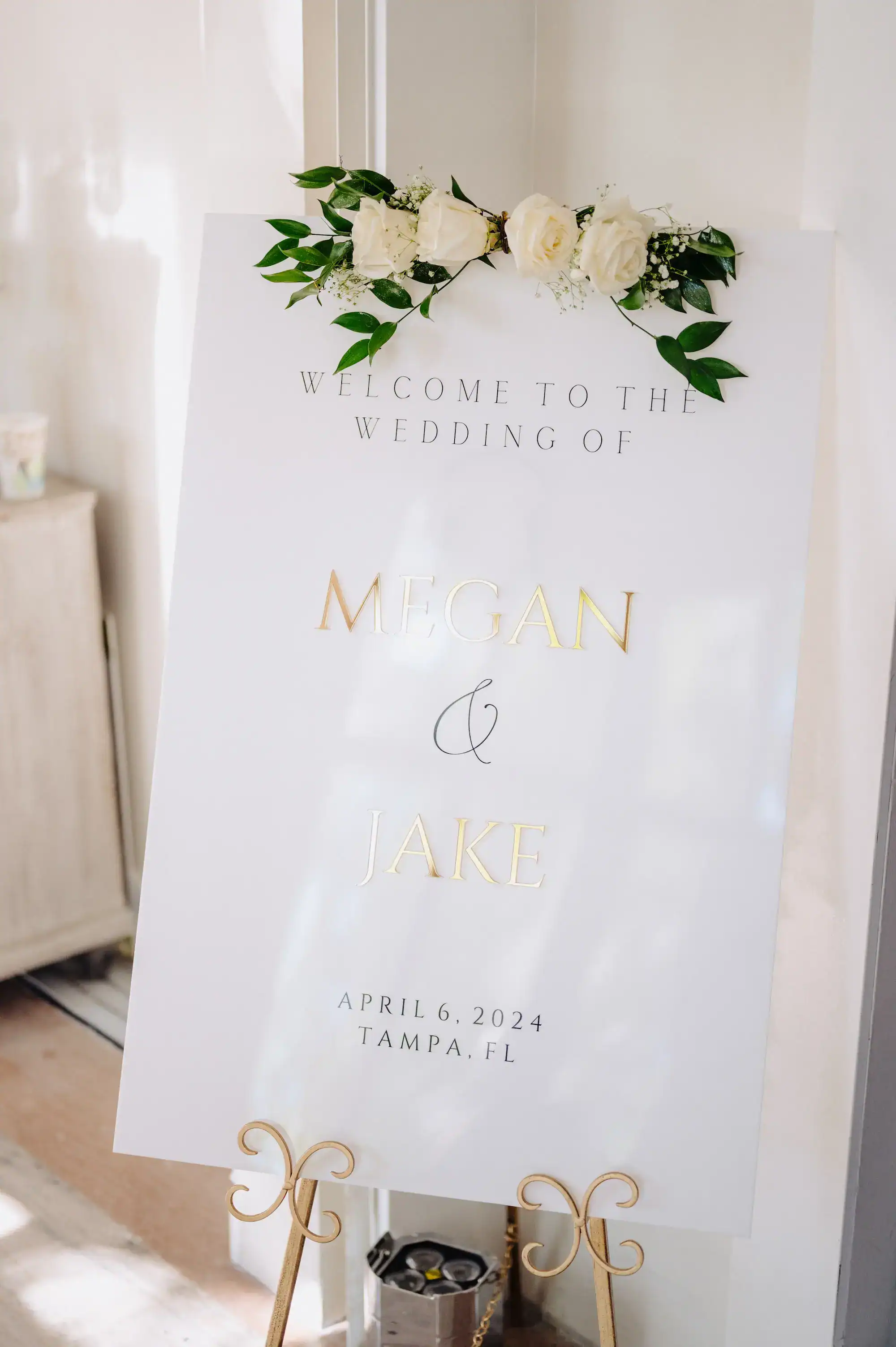 Interior view of The Vault wedding venue with marble columns and white florals.