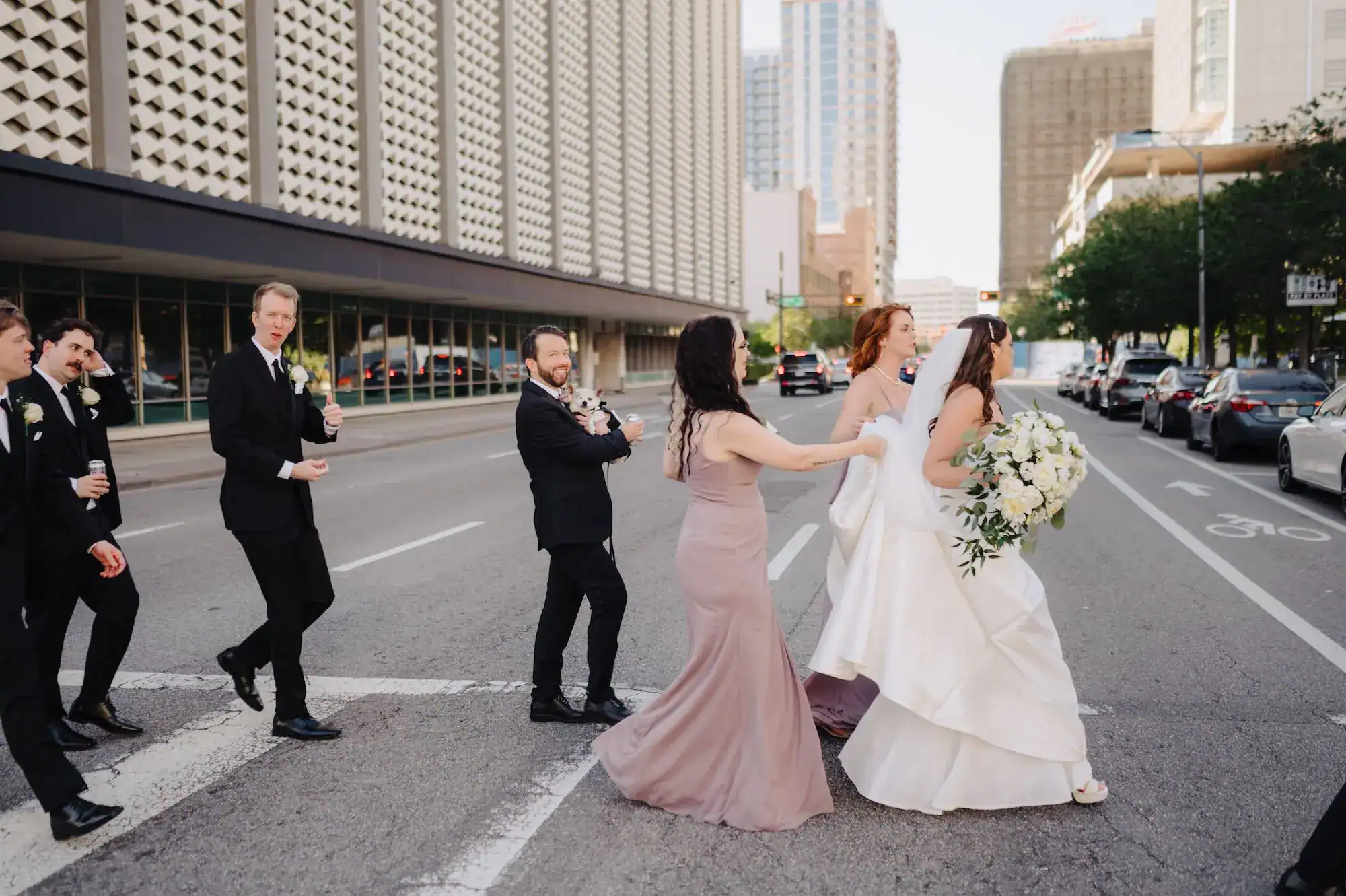 Wedding guests dancing on stone floors inside a historic Tampa bank building venue.