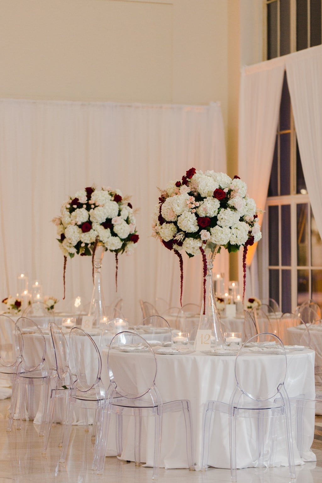 Grand Ballroom Reception at The Vault with Acrylic Ghost Chairs and Tall Floral Centerpieces by Gabro Event Services