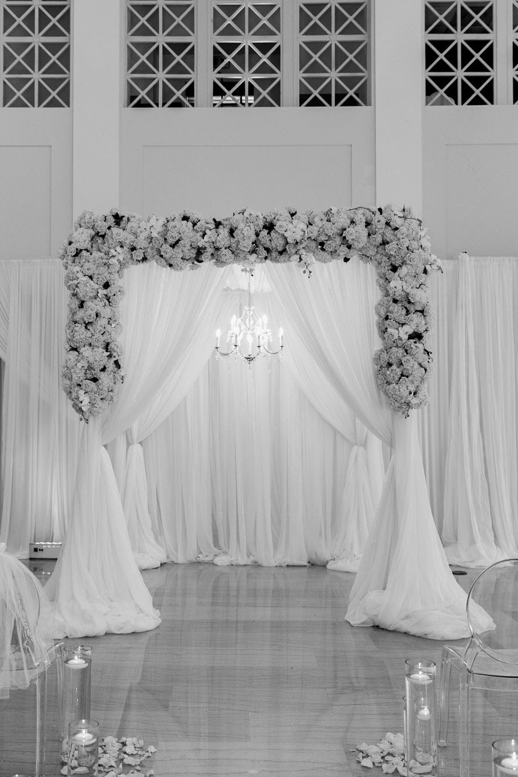 White Chiffon Ceremony Draping with Floral Cascades and Hanging Crystal Chandelier by Gabro Event Services