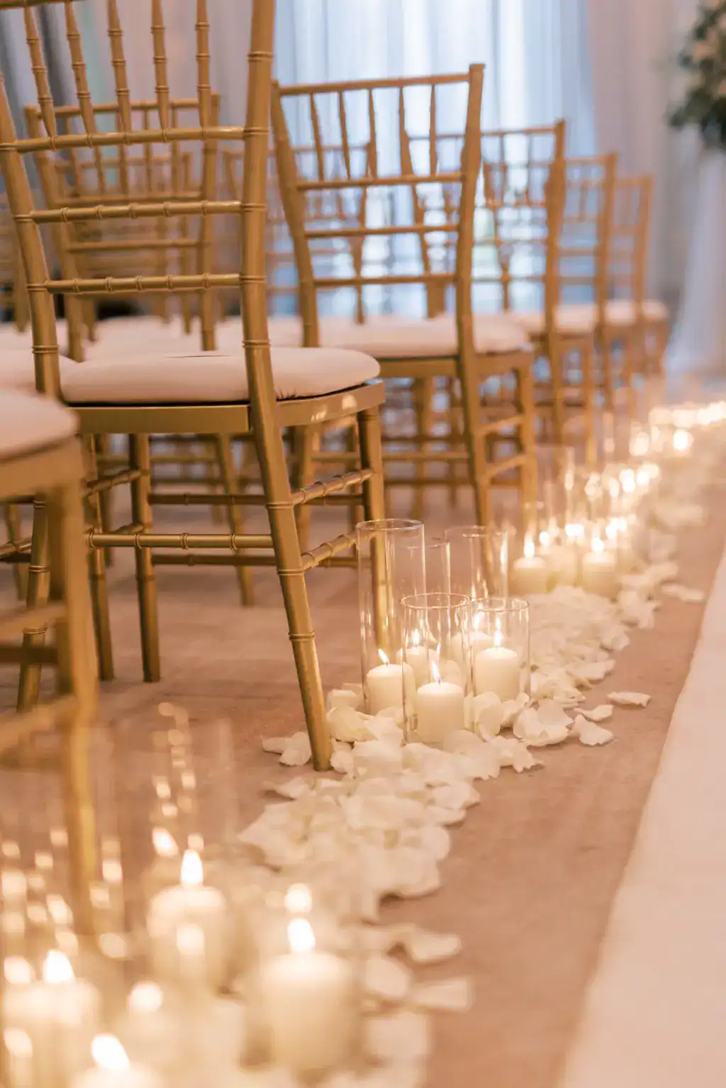Gold Chiavari chairs beside a candlelit aisle at The Vinoy