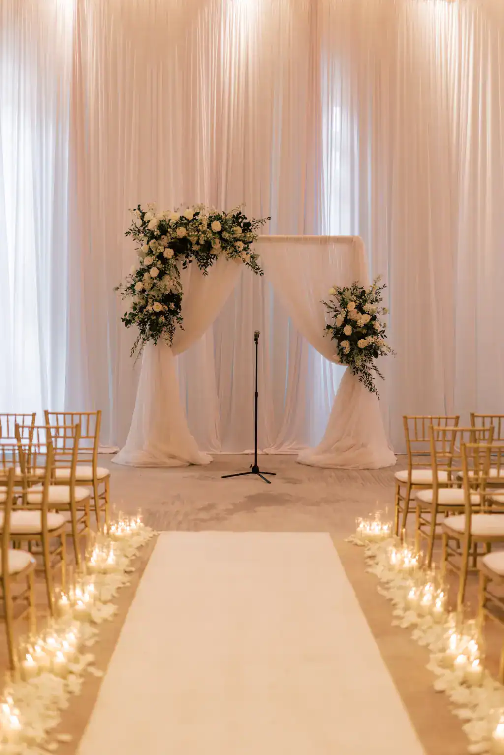 Romantic white pipe and drape wedding ceremony arch on the Vinoy Esplanade Courtyard